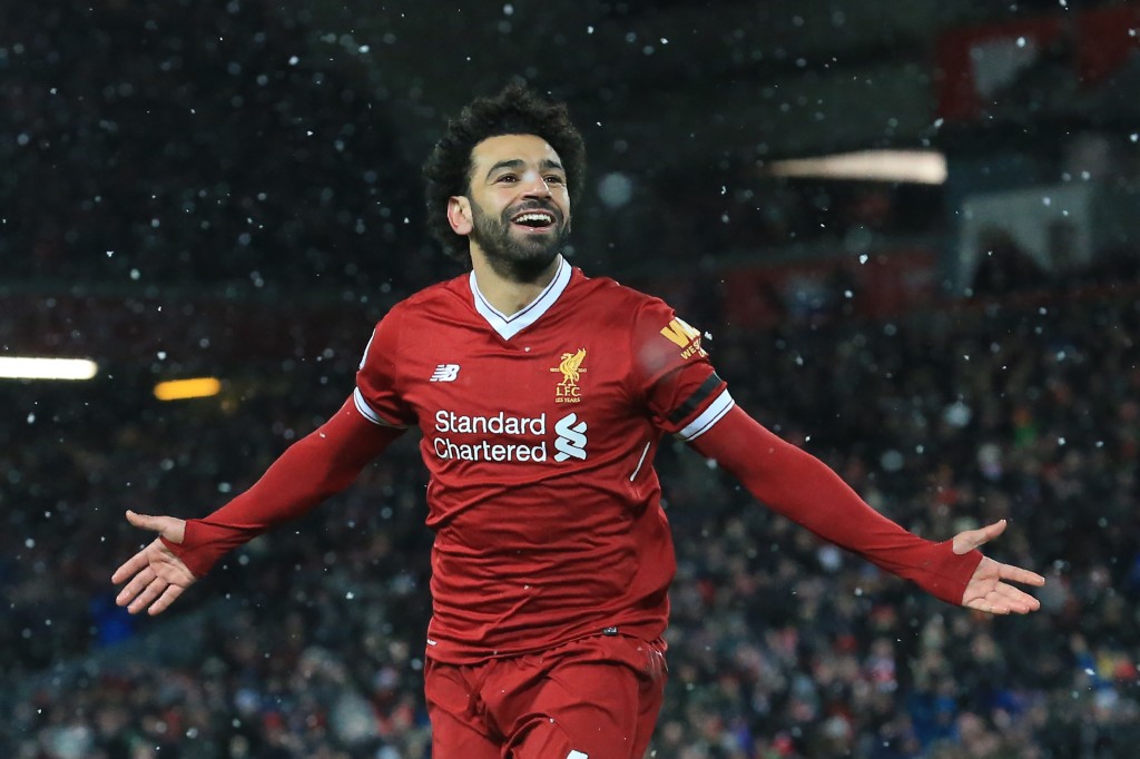 Liverpool's Egyptian midfielder Mohamed Salah celebrates scoring the team's fourth goal during the English Premier League football match between Liverpool and Watford at Anfield in Liverpool, north west England on March 17, 2018. / AFP PHOTO / Lindsey PARNABY / RESTRICTED TO EDITORIAL USE. No use with unauthorized audio, video, data, fixture lists, club/league logos or 'live' services. Online in-match use limited to 75 images, no video emulation. No use in betting, games or single club/league/player publications. / (Photo credit should read LINDSEY PARNABY/AFP/Getty Images)