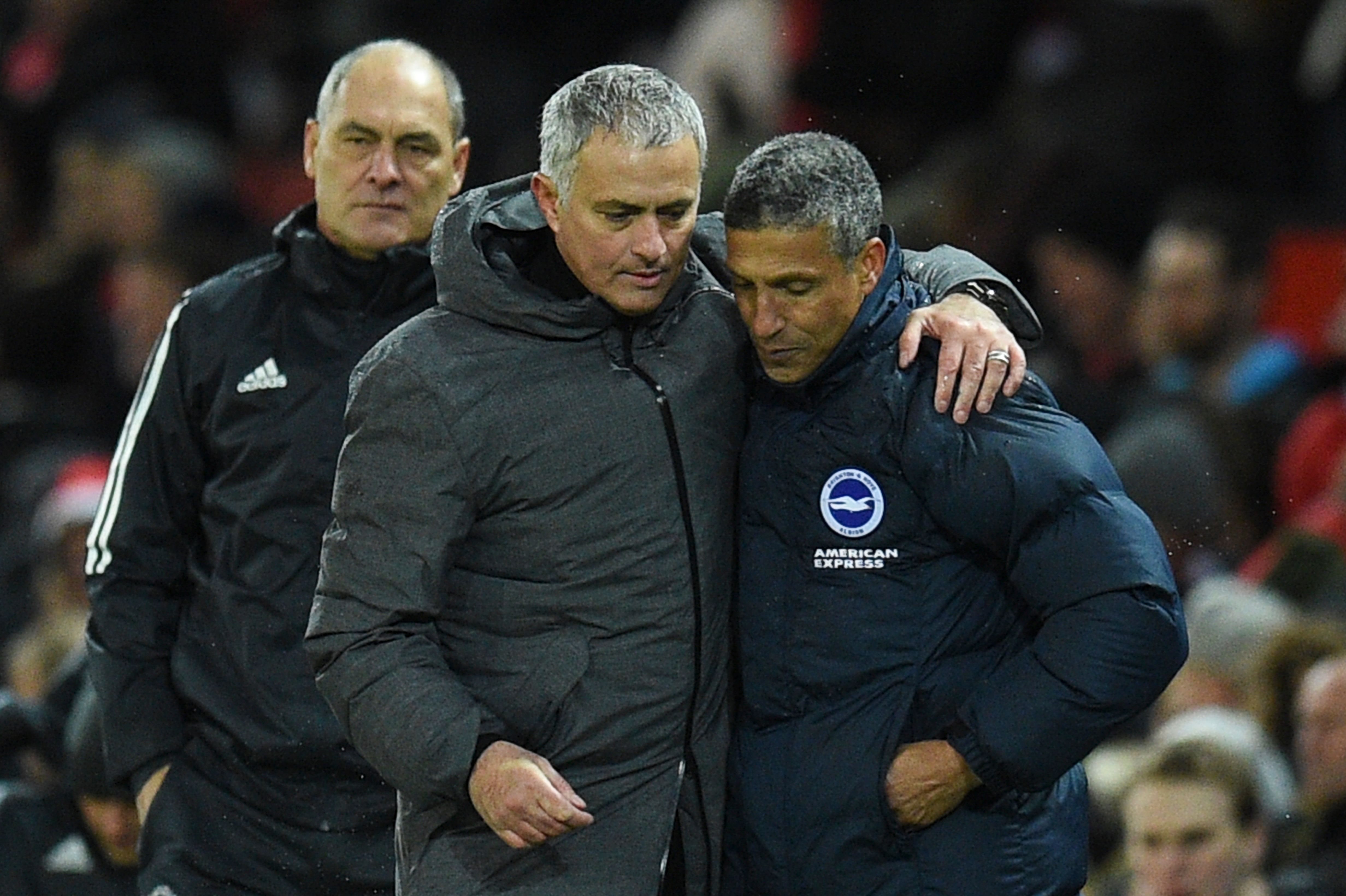 Manchester United's Portuguese manager Jose Mourinho (2R) leaves the pitch with Brighton's Irish manager Chris Hughton (R) during the English Premier League football match between Manchester United and Brighton and Hove Albion at Old Trafford in Manchester, north west England, on November 25, 2017. / AFP PHOTO / Oli SCARFF / RESTRICTED TO EDITORIAL USE. No use with unauthorized audio, video, data, fixture lists, club/league logos or 'live' services. Online in-match use limited to 75 images, no video emulation. No use in betting, games or single club/league/player publications. / (Photo credit should read OLI SCARFF/AFP/Getty Images)
