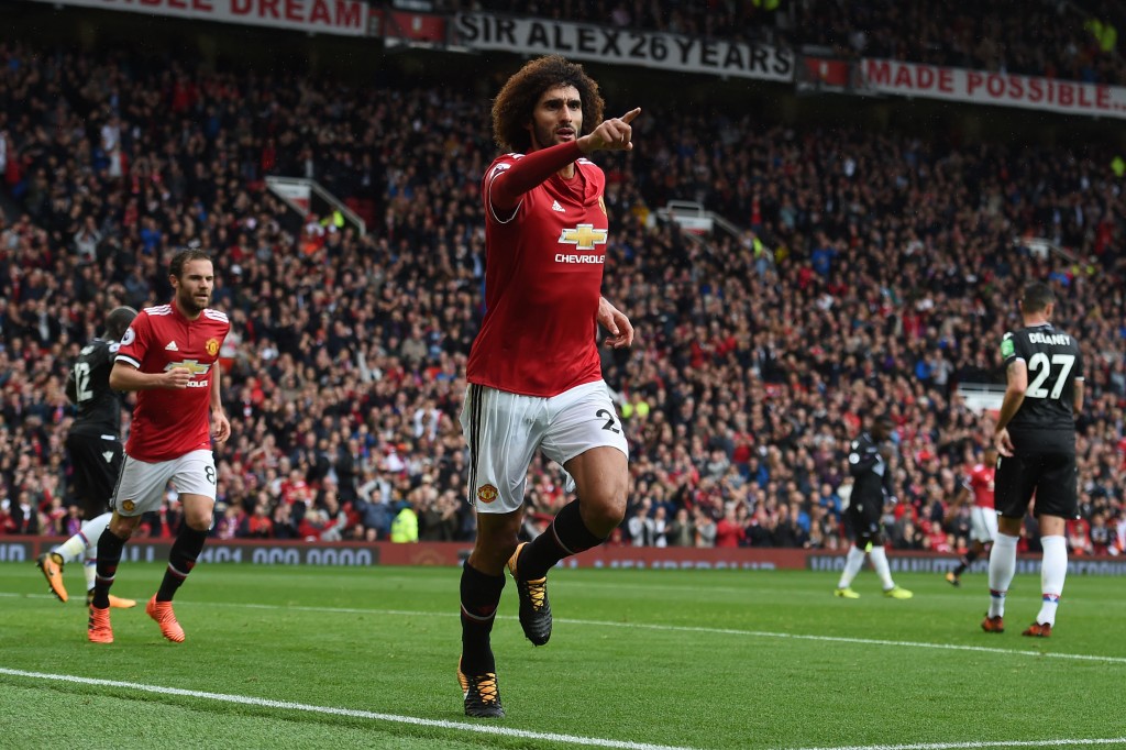 Manchester United's Belgian midfielder Marouane Fellaini celebrates scoring the team's second goal during the English Premier League football match between Manchester United and Crystal Palace at Old Trafford in Manchester, north west England, on September 30, 2017. / AFP PHOTO / PAUL ELLIS / RESTRICTED TO EDITORIAL USE. No use with unauthorized audio, video, data, fixture lists, club/league logos or 'live' services. Online in-match use limited to 75 images, no video emulation. No use in betting, games or single club/league/player publications. / (Photo credit should read PAUL ELLIS/AFP/Getty Images)