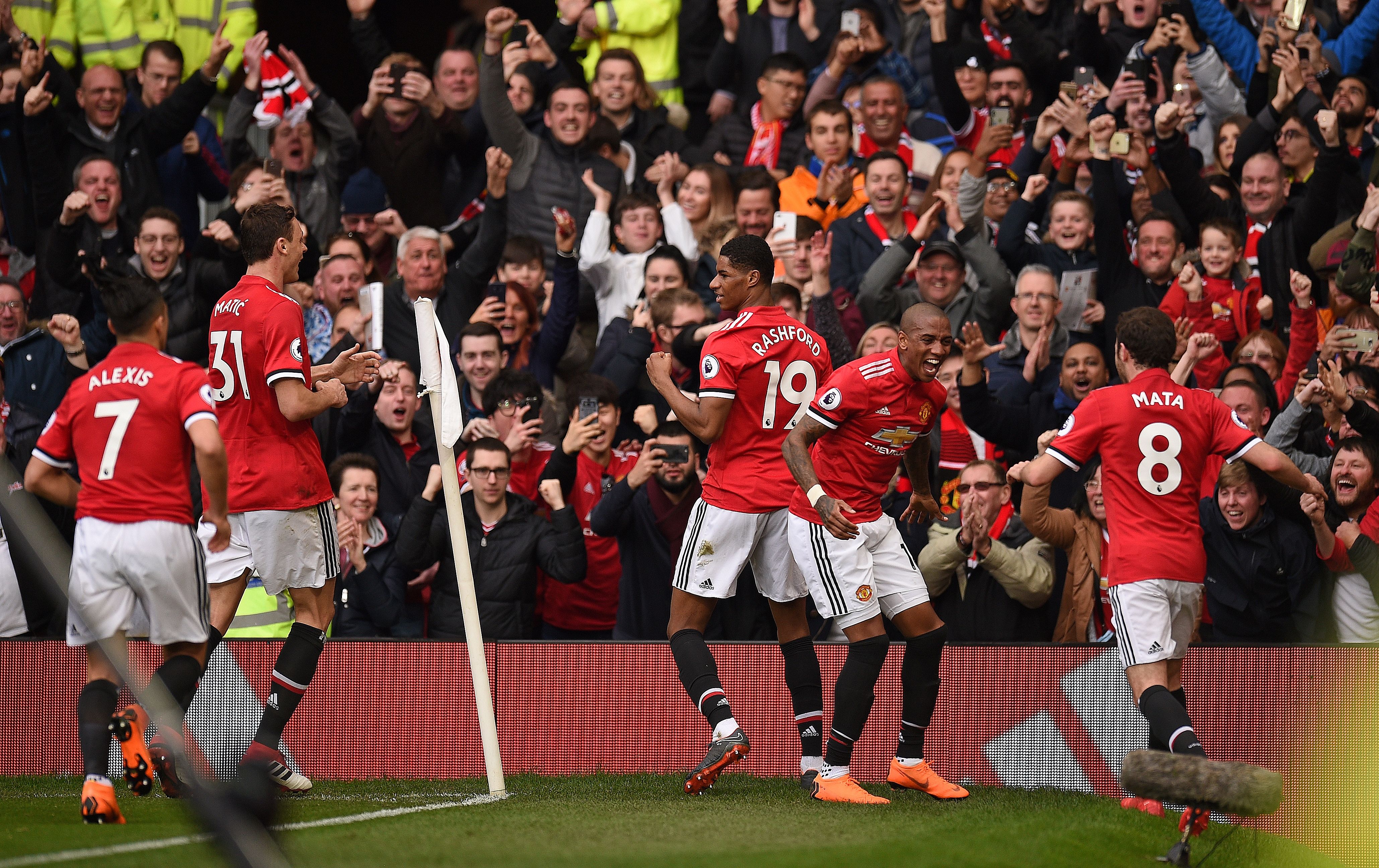 Manchester United players celebrate after Manchester United's English striker Marcus Rashford (C) scored their second goal during the English Premier League football match between Manchester United and Liverpool at Old Trafford in Manchester, north west England, on March 10, 2018. / AFP PHOTO / Oli SCARFF / RESTRICTED TO EDITORIAL USE. No use with unauthorized audio, video, data, fixture lists, club/league logos or 'live' services. Online in-match use limited to 75 images, no video emulation. No use in betting, games or single club/league/player publications. / (Photo credit should read OLI SCARFF/AFP/Getty Images)