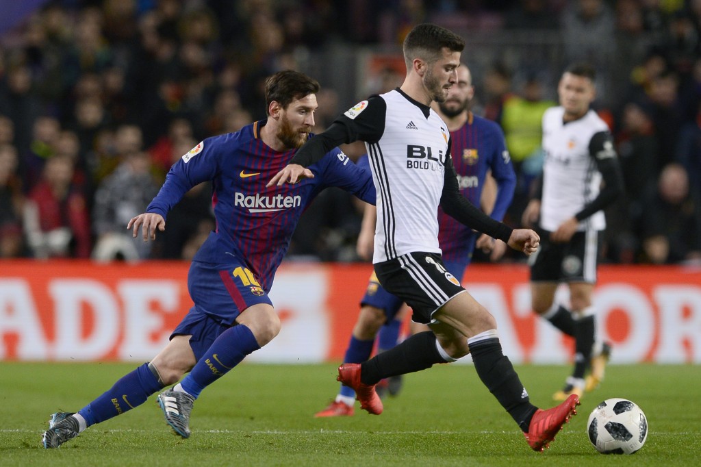 Barcelona's Argentinian forward Lionel Messi (L) vies with Valencia's Spanish defender Jose Luis Gaya Pena during the Spanish 'Copa del Rey' (King's cup) first leg semi-final football match between FC Barcelona and Valencia CF at the Camp Nou stadium in Barcelona on February 01, 2018. / AFP PHOTO / Josep LAGO (Photo credit should read JOSEP LAGO/AFP/Getty Images)