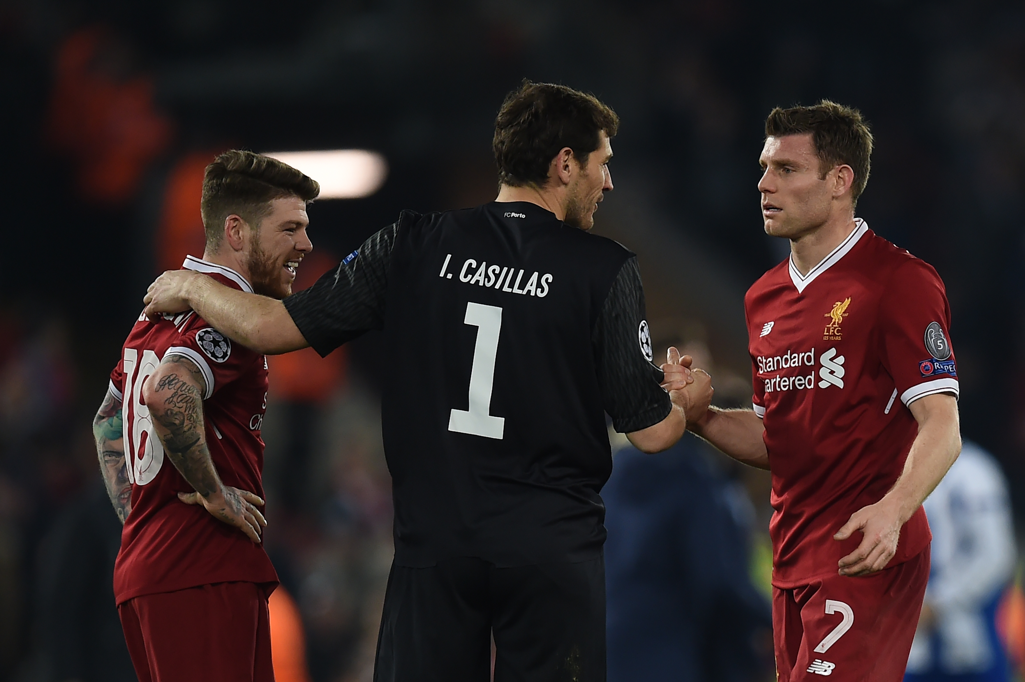 Porto's Spanish goalkeeper Iker Casillas (C) greets Liverpool's Spanish defender Alberto Moreno (L) and Liverpool's English midfielder James Milner after the UEFA Champions League round of sixteen second leg football match between Liverpool and FC Porto at Anfield in Liverpool, north-west England on March 6, 2018. / AFP PHOTO / PAUL ELLIS (Photo credit should read PAUL ELLIS/AFP/Getty Images)