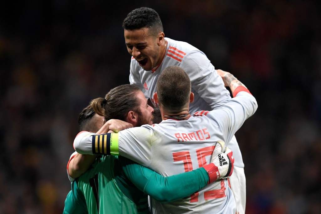 (L-R) Spain's goalkeeper David de Gea, Spain's midfielder Thiago and Spain's defender Sergio Ramos celebrate a goal during a friendly football match between Spain and Argentina at the Wanda Metropolitano Stadium in Madrid on March 27, 2018. / AFP PHOTO / GABRIEL BOUYS (Photo credit should read GABRIEL BOUYS/AFP/Getty Images)
