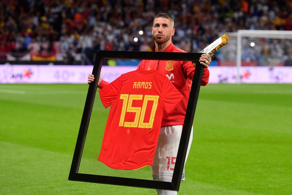 Spain's defender Sergio Ramos poses with a special framed jersey marking his 150th cap for Spain before a friendly football match between Spain and Argentina at the Wanda Metropolitano Stadium in Madrid on March 27, 2018. / AFP PHOTO / PIERRE-PHILIPPE MARCOU (Photo credit should read PIERRE-PHILIPPE MARCOU/AFP/Getty Images)