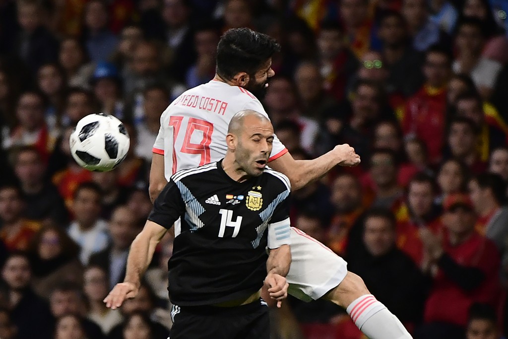 Spain's forward Diego Costa (back) heads the ball with Argentina's defender Javier Mascherano during a friendly football match between Spain and Argentina at the Wanda Metropolitano Stadium in Madrid on March 27, 2018. / AFP PHOTO / PIERRE-PHILIPPE MARCOU (Photo credit should read PIERRE-PHILIPPE MARCOU/AFP/Getty Images)