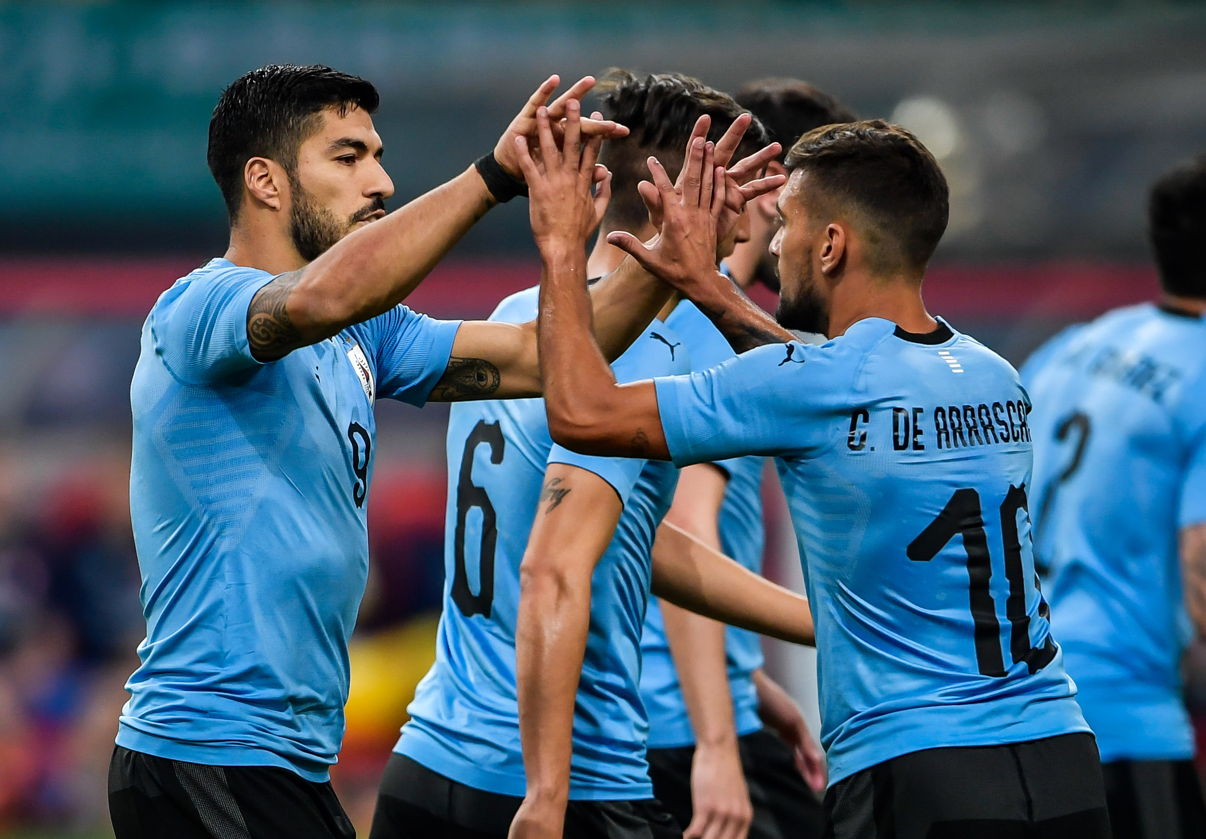 Luis Suarez (L) of Uruguay celebrates with teammate Giorian De Arrascaeta (R, #10) during their China Cup International Football Championship Semi-final match against Czech in Nanning in China's southern Guangxi region on March 23, 2018. / AFP PHOTO / - / China OUT (Photo credit should read -/AFP/Getty Images)