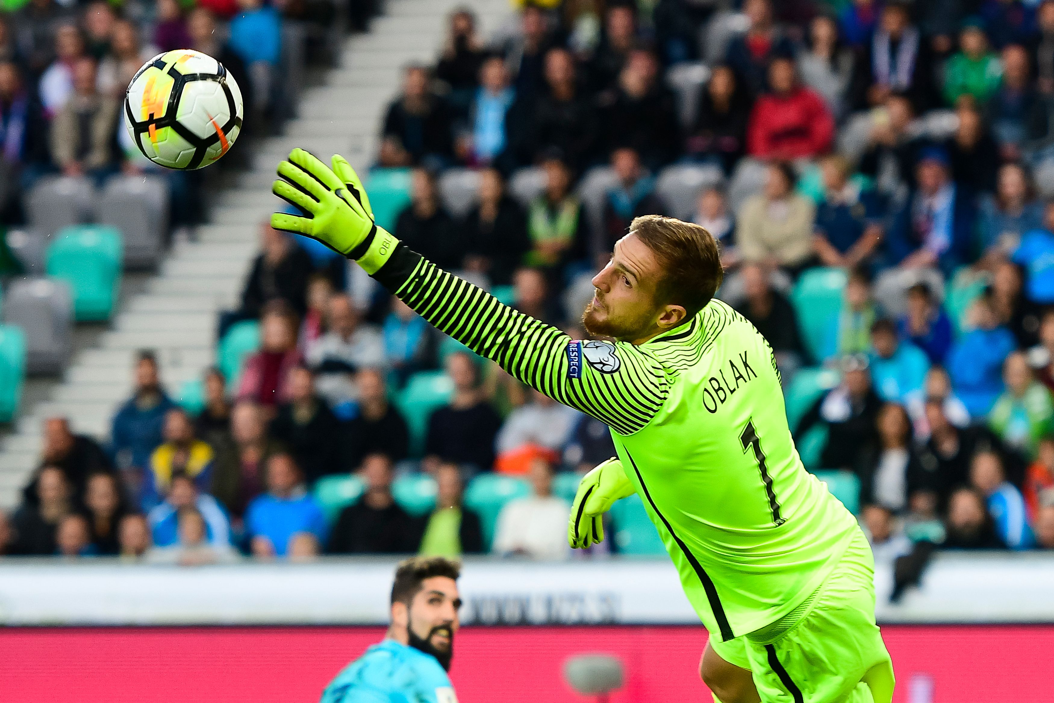 Slovenia's goalkeeper Jan Oblak goes for the save during the FIFA World Cup 2018 qualifier football match between Slovenia and Scotland at the Stozice stadium in Ljubljana, on October 8, 2017. / AFP PHOTO / Jure Makovec (Photo credit should read JURE MAKOVEC/AFP/Getty Images)