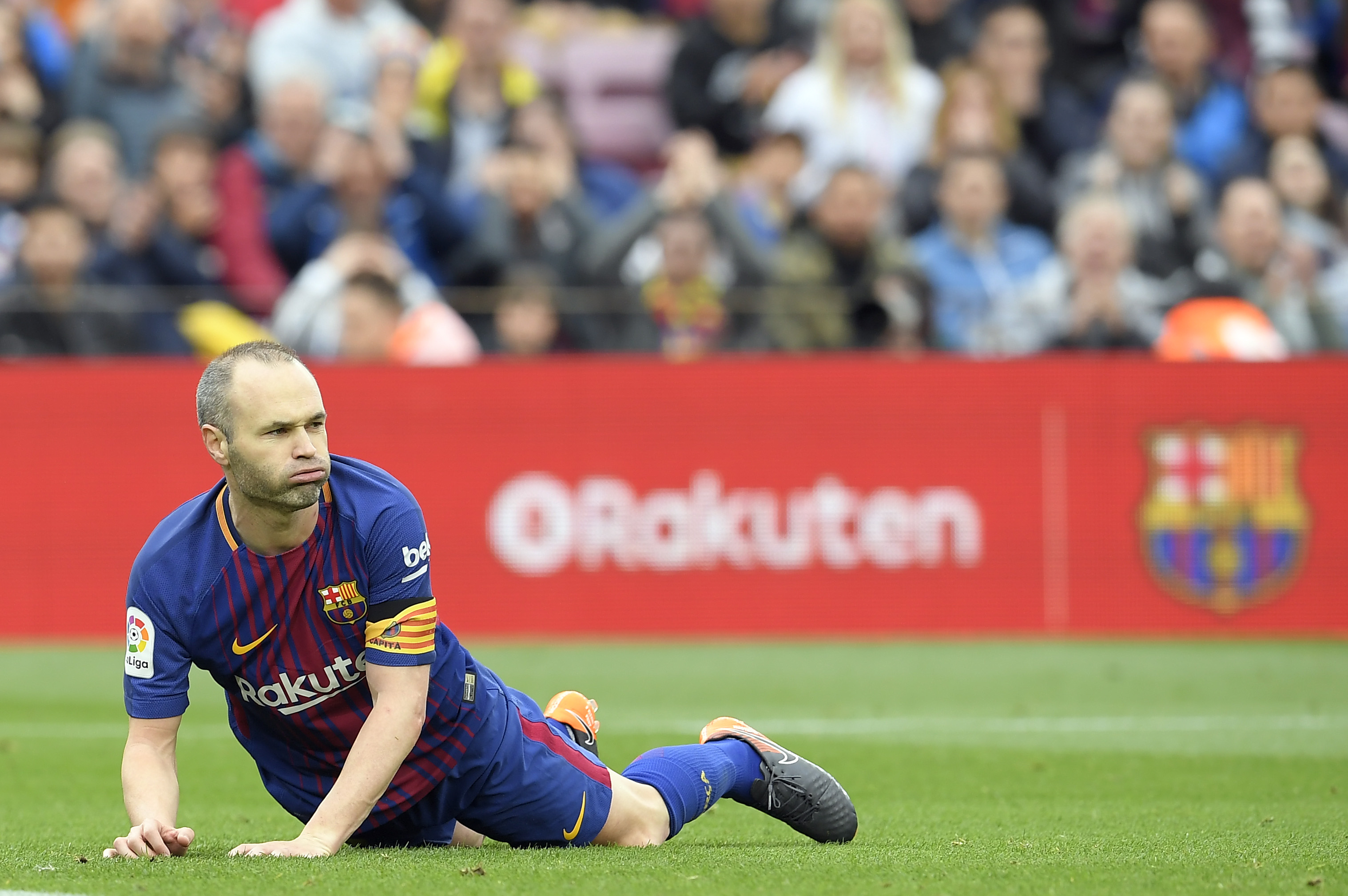 Barcelona's Spanish midfielder Andres Iniesta lies on the field during the Spanish league footbal match between FC Barcelona and Valencia CF at the Camp Nou stadium in Barcelona on April 14, 2018. / AFP PHOTO / LLUIS GENE (Photo credit should read LLUIS GENE/AFP/Getty Images)