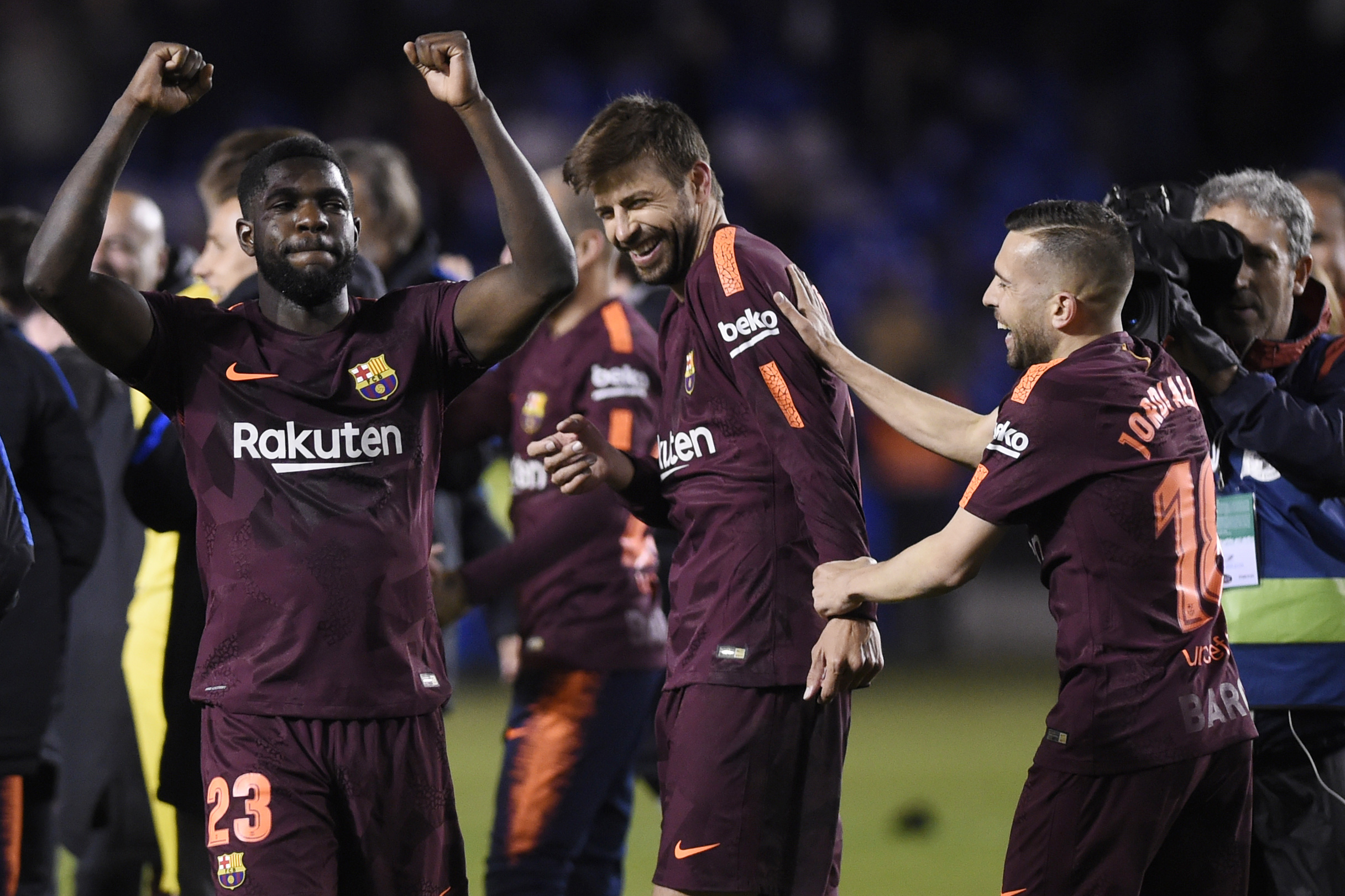 (L-R) Barcelona's French defender Samuel Umtiti, Barcelona's Spanish defender Gerard Pique and Barcelona's Spanish defender Jordi Alba celebrate after their team won the Spanish league football match against Deportivo Coruna and claimed their 25th La Liga at the Riazor stadium in Coruna on April 29, 2018. (Photo by MIGUEL RIOPA / AFP) (Photo credit should read MIGUEL RIOPA/AFP/Getty Images)