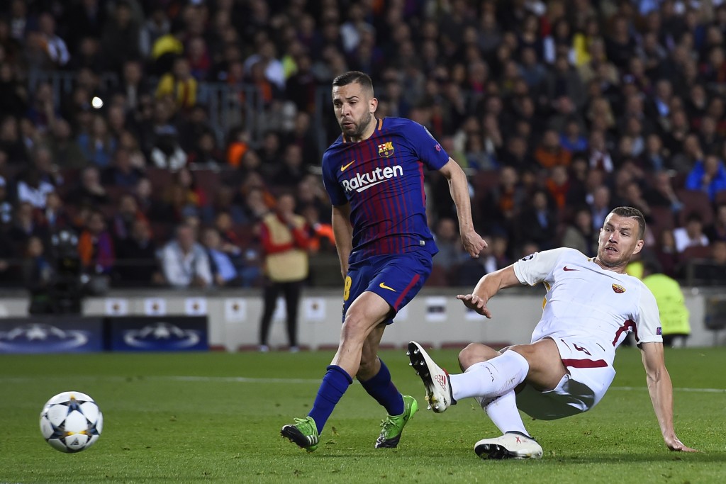 Roma's Bosnian striker Edin Dzeko (R) scores a goal past Barcelona's Spanish defender Jordi Alba during the UEFA Champions League quarter-final first leg football match between Barcelona and AS Roma at the Camp Nou Stadium in Barcelona on April 4, 2018. / AFP PHOTO / Josep LAGO (Photo credit should read JOSEP LAGO/AFP/Getty Images)