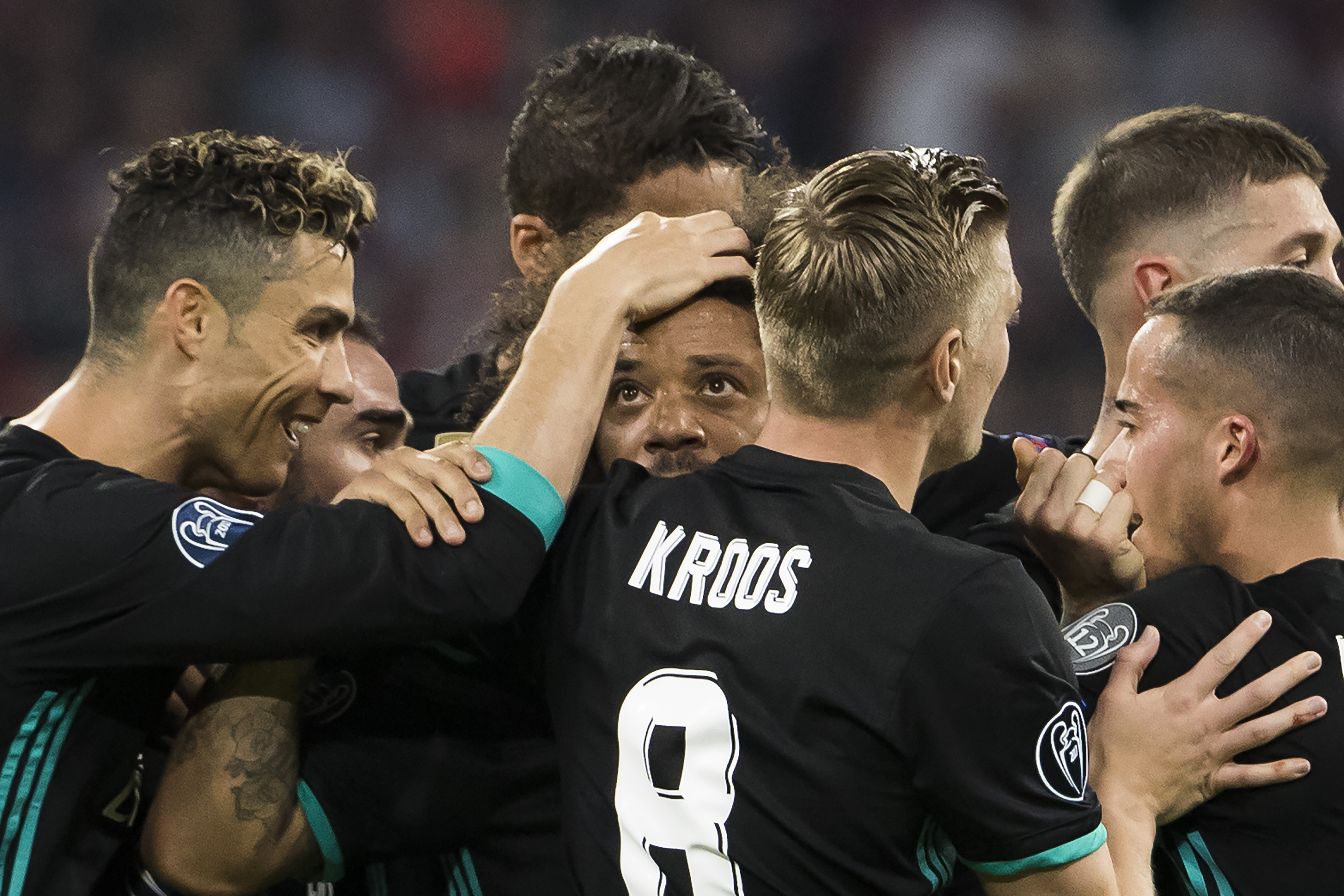 Real Madrid's Brazilian defender Marcelo (C) is congratulated after scoring by Real Madrid's Portuguese forward Cristiano Ronaldo (L) and other team matesd during the UEFA Champions League semi-final first-leg football match FC Bayern Munich v Real Madrid CF in Munich, southern Germany on April 25, 2018. (Photo by ODD ANDERSEN / AFP) (Photo credit should read ODD ANDERSEN/AFP/Getty Images)