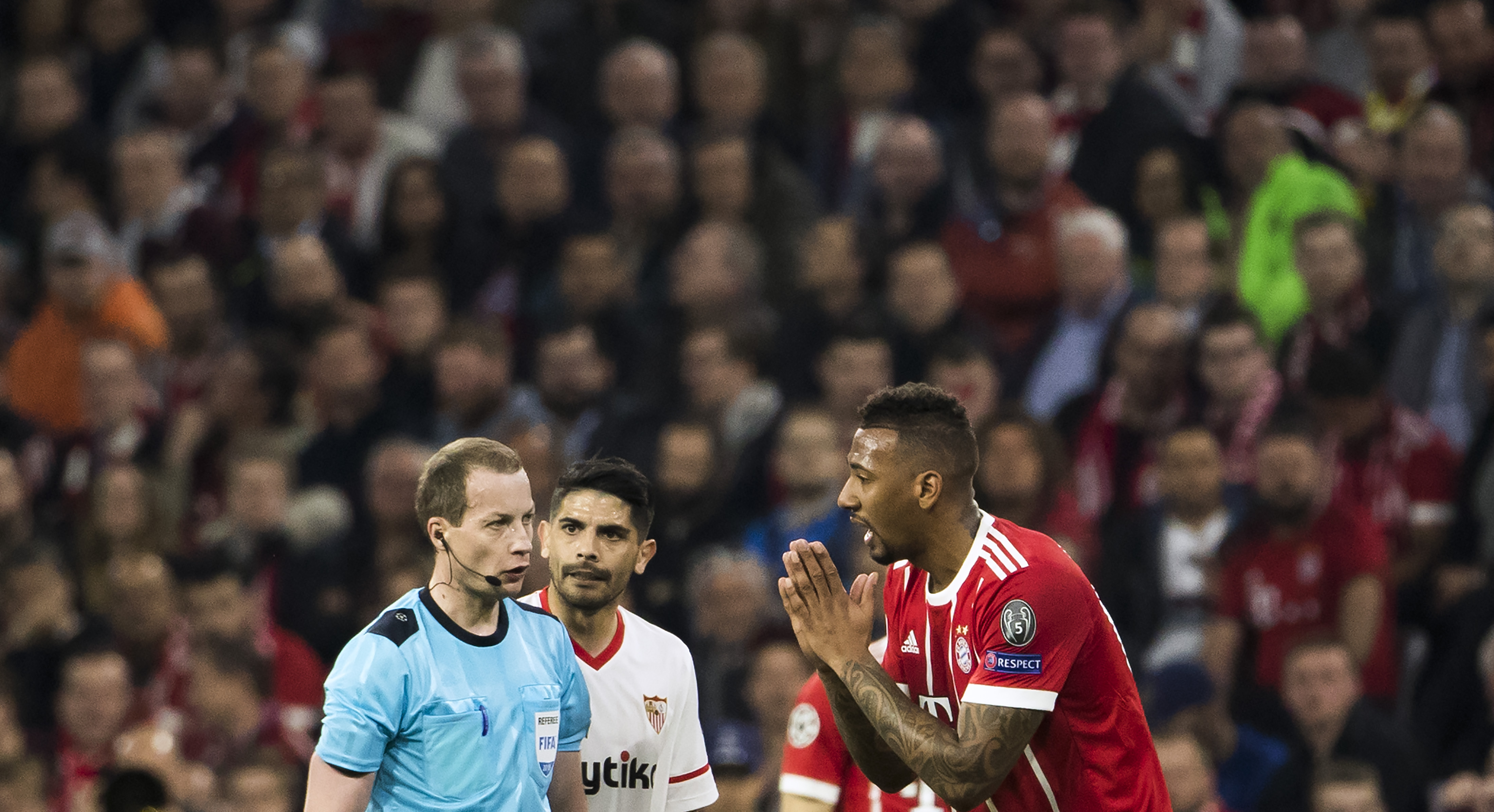 Germany's defender Jerome Boateng (R) pleads with Scottish referee William Collum during the UEFA Champions League quarter-final second leg football match between Bayern Munich and Sevilla FC on April 11, 2018 in Munich, southern Germany. / AFP PHOTO / Odd ANDERSEN (Photo credit should read ODD ANDERSEN/AFP/Getty Images)