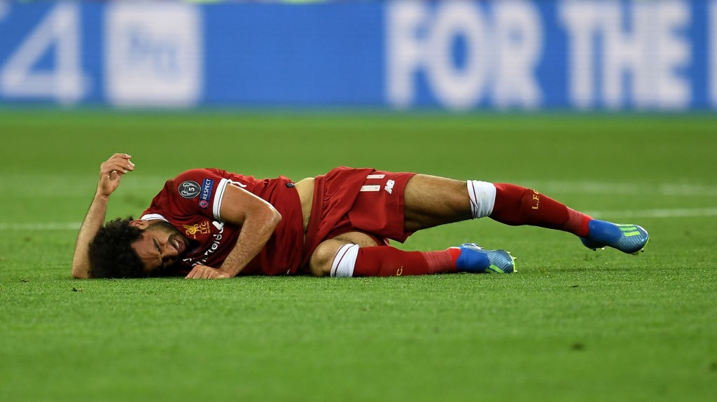 Mohamed Salah lies on the floor injured after a clash with Sergio Ramos. (Photo courtesy: AFP/Getty)