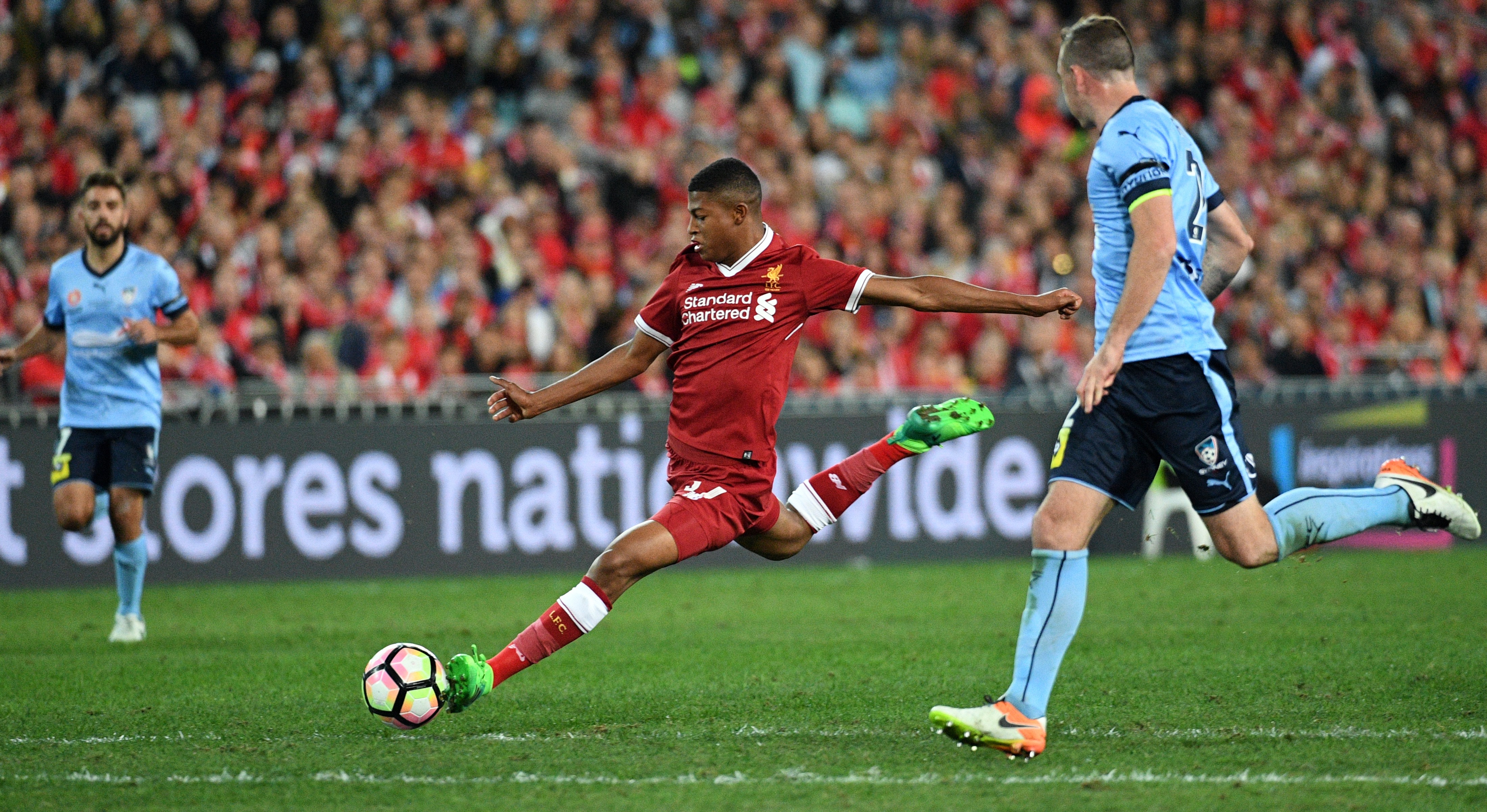 Liverpool player Rhian Brewster (C) shoots on goal as Sydney FC player Sebastian Ryall (R) looks on during their end-of-season friendly football match at the Olympic Stadium in Sydney on May 24, 2017. / AFP PHOTO / WILLIAM WEST / IMAGE RESTRICTED TO EDITORIAL USE - STRICTLY NO COMMERCIAL USE (Photo credit should read WILLIAM WEST/AFP/Getty Images)