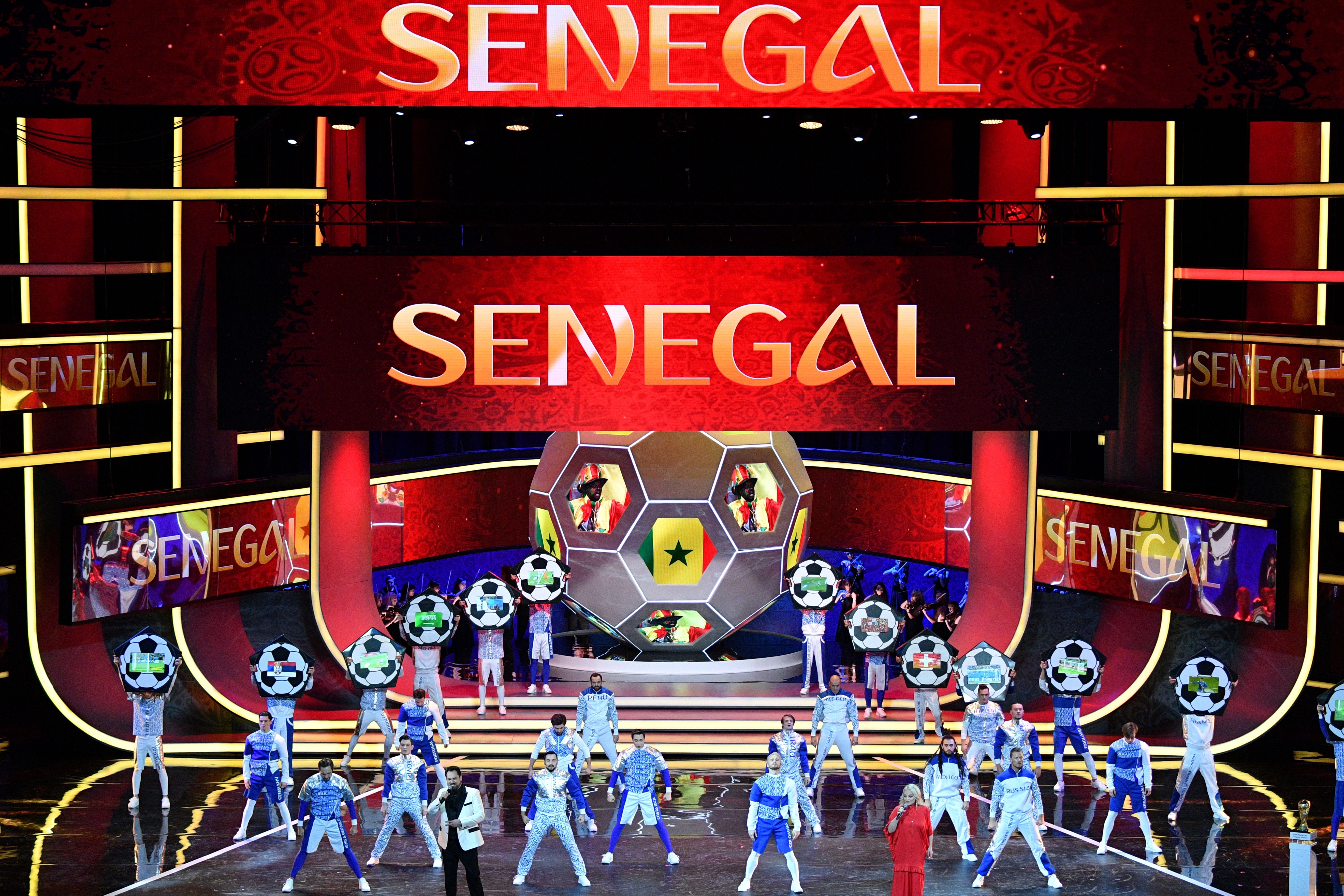 Artists perform on stage as "Senegal" is displayed on screens during the Final Draw for the 2018 FIFA World Cup football tournament at the State Kremlin Palace in Moscow on December 1, 2017.
The 2018 FIFA World Cup will be held from June 14 and July 15, 2018, in 11 Russian cities. / AFP PHOTO / Mladen ANTONOV (Photo credit should read MLADEN ANTONOV/AFP/Getty Images)