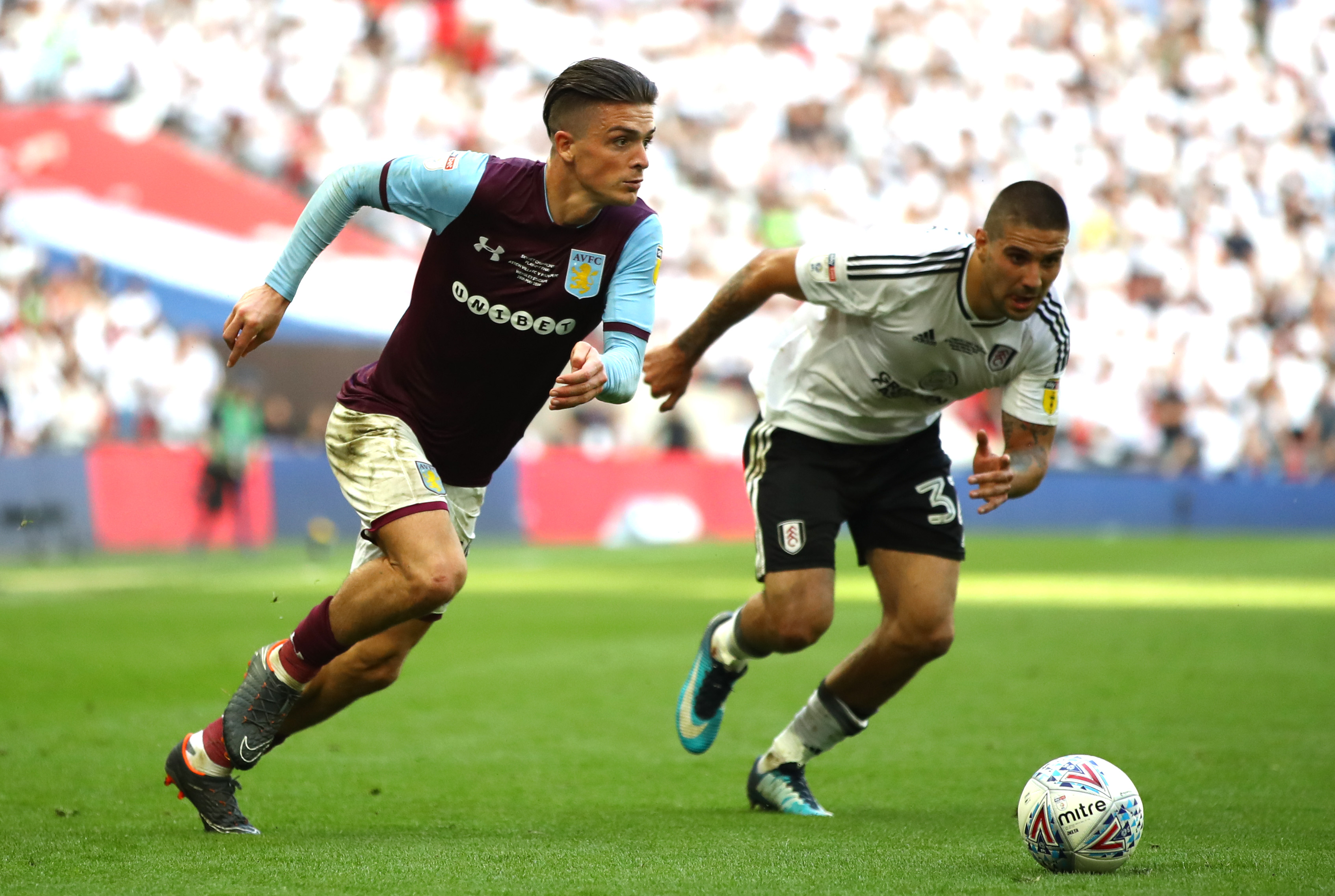 LONDON, ENGLAND - MAY 26: Jack Grealish of Aston Villa runs with the ball under pressure from Aleksandar Mitrovic of Fulham during the Sky Bet Championship Play Off Final between Aston Villa and Fulham at Wembley Stadium on May 26, 2018 in London, England. (Photo by Clive Mason/Getty Images)