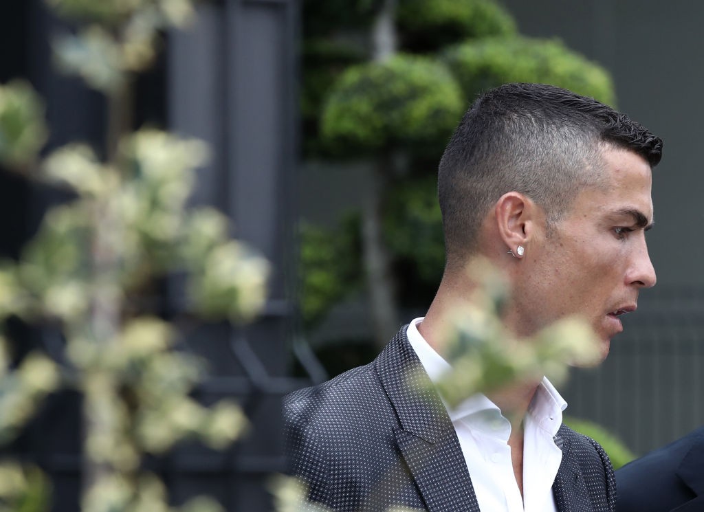 Portuguese footballer Cristiano Ronaldo walks out the Juventus medical center at the Alliance stadium in Turin on July 16, 2018 as he greets supporters. - Cristiano Ronaldo arrived in Turin ahead of his official unveiling as Juventus' superstar summer signing on July 17. (Photo by Isabella Bonotto / AFP) (Photo credit should read ISABELLA BONOTTO/AFP/Getty Images)