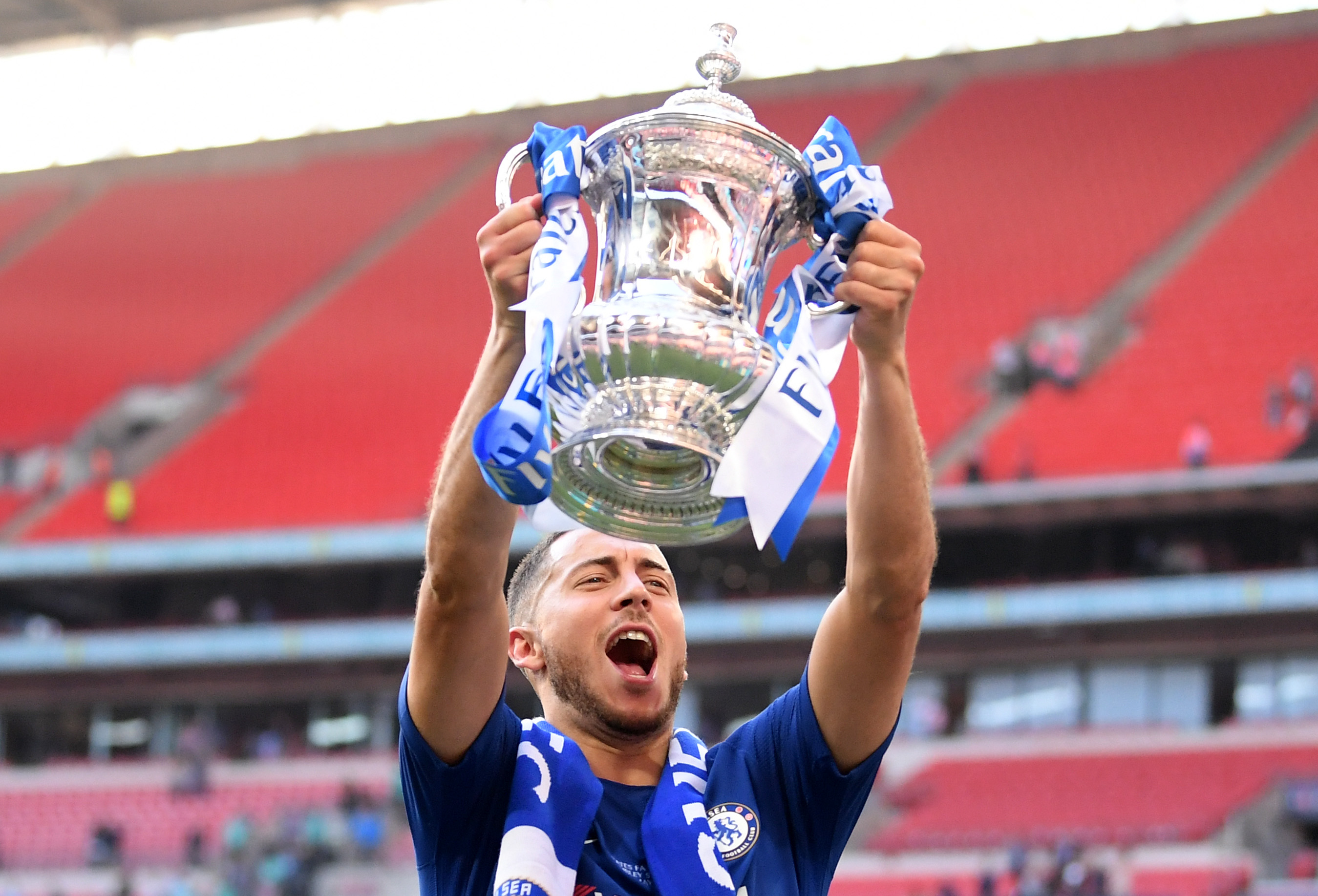 LONDON, ENGLAND - MAY 19:  Eden Hazard of Chelsea celebrates with the Emirates FA Cup Trophy following his sides victory in The Emirates FA Cup Final between Chelsea and Manchester United at Wembley Stadium on May 19, 2018 in London, England.  (Photo by Laurence Griffiths/Getty Images)