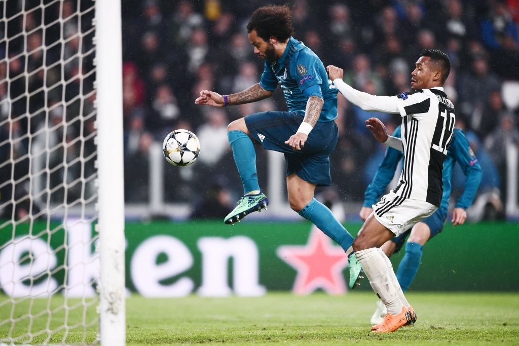Real Madrid's Brazilian defender Marcelo (L) scores his team's third goal next to Juventus' Brazilian defender Alex Sandro during the UEFA Champions League quarter-final first leg football match between Juventus and Real Madrid at the Allianz Stadium in Turin on April 3, 2018. / AFP PHOTO / Marco BERTORELLO (Photo credit should read MARCO BERTORELLO/AFP/Getty Images)