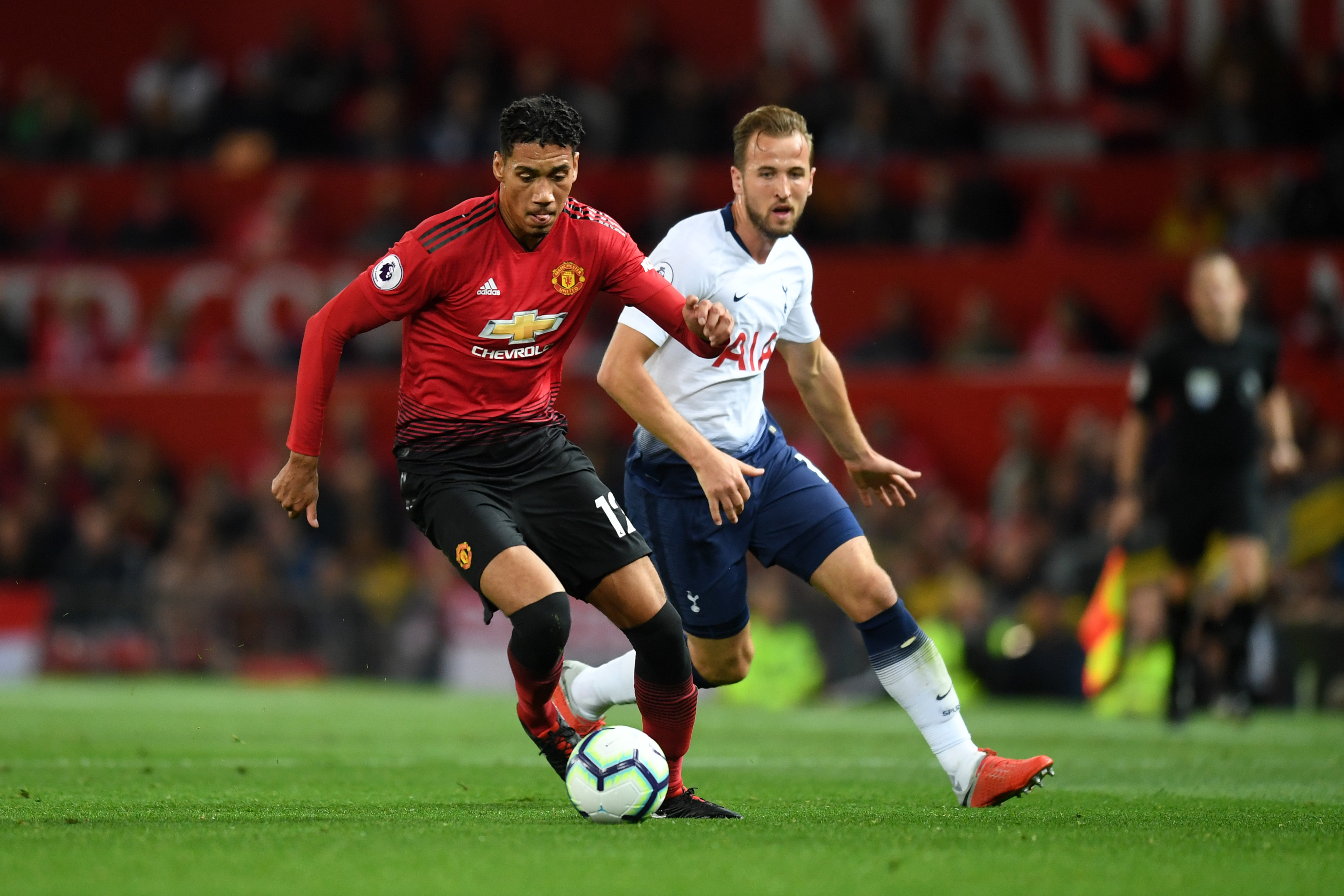 MANCHESTER, ENGLAND - AUGUST 27: Chris Smalling of Manchester United and Harry Kane of Tottenham Hotspur in action during the Premier League match between Manchester United and Tottenham Hotspur at Old Trafford on August 27, 2018 in Manchester, United Kingdom. (Photo by Michael Regan/Getty Images)