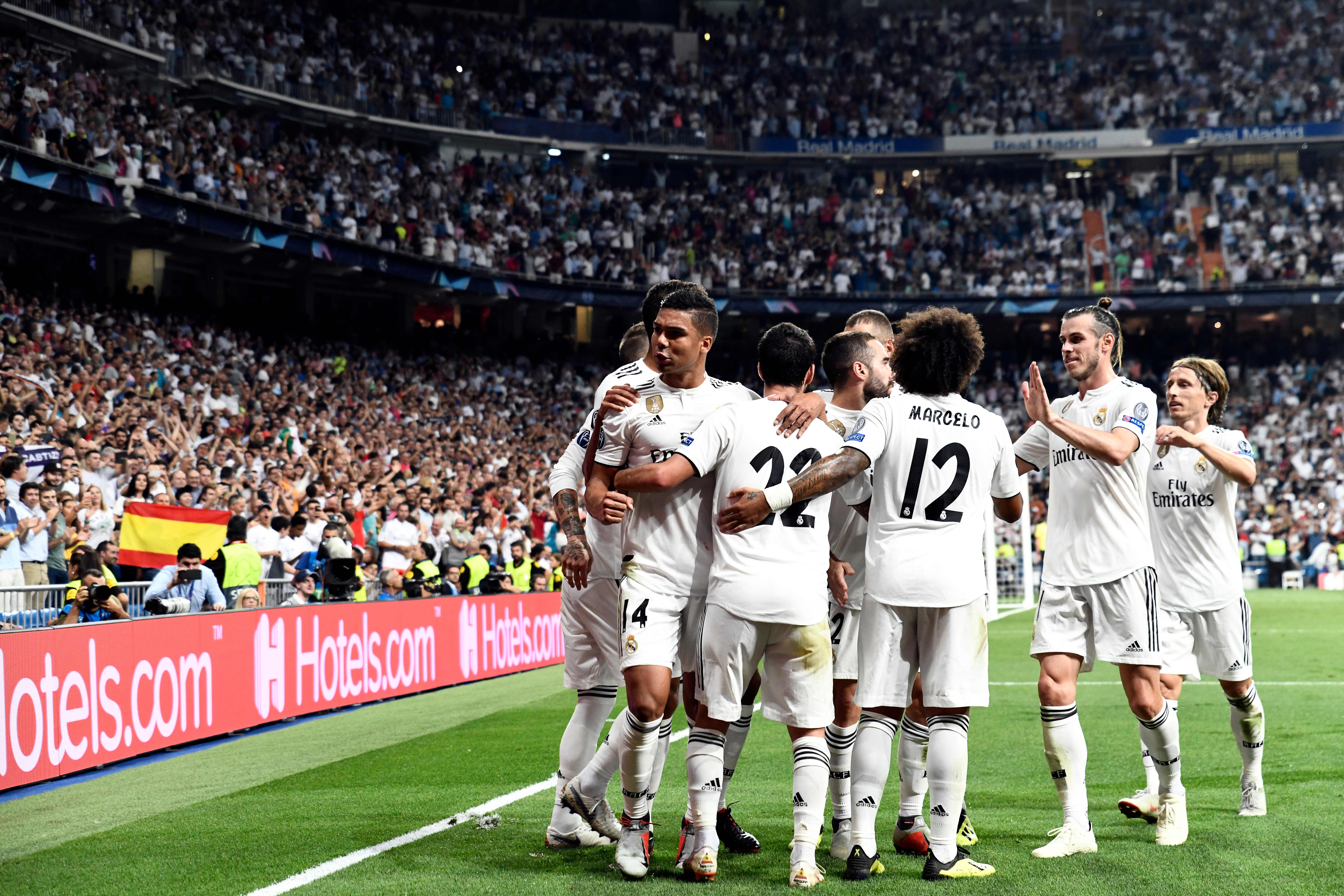 Real Madrid players celebrate the opening goal during the UEFA Champions League group G football match between Real Madrid CF and AS Roma at the Santiago Bernabeu stadium in Madrid on September 19, 2018. (Photo by OSCAR DEL POZO / AFP) (Photo credit should read OSCAR DEL POZO/AFP/Getty Images)