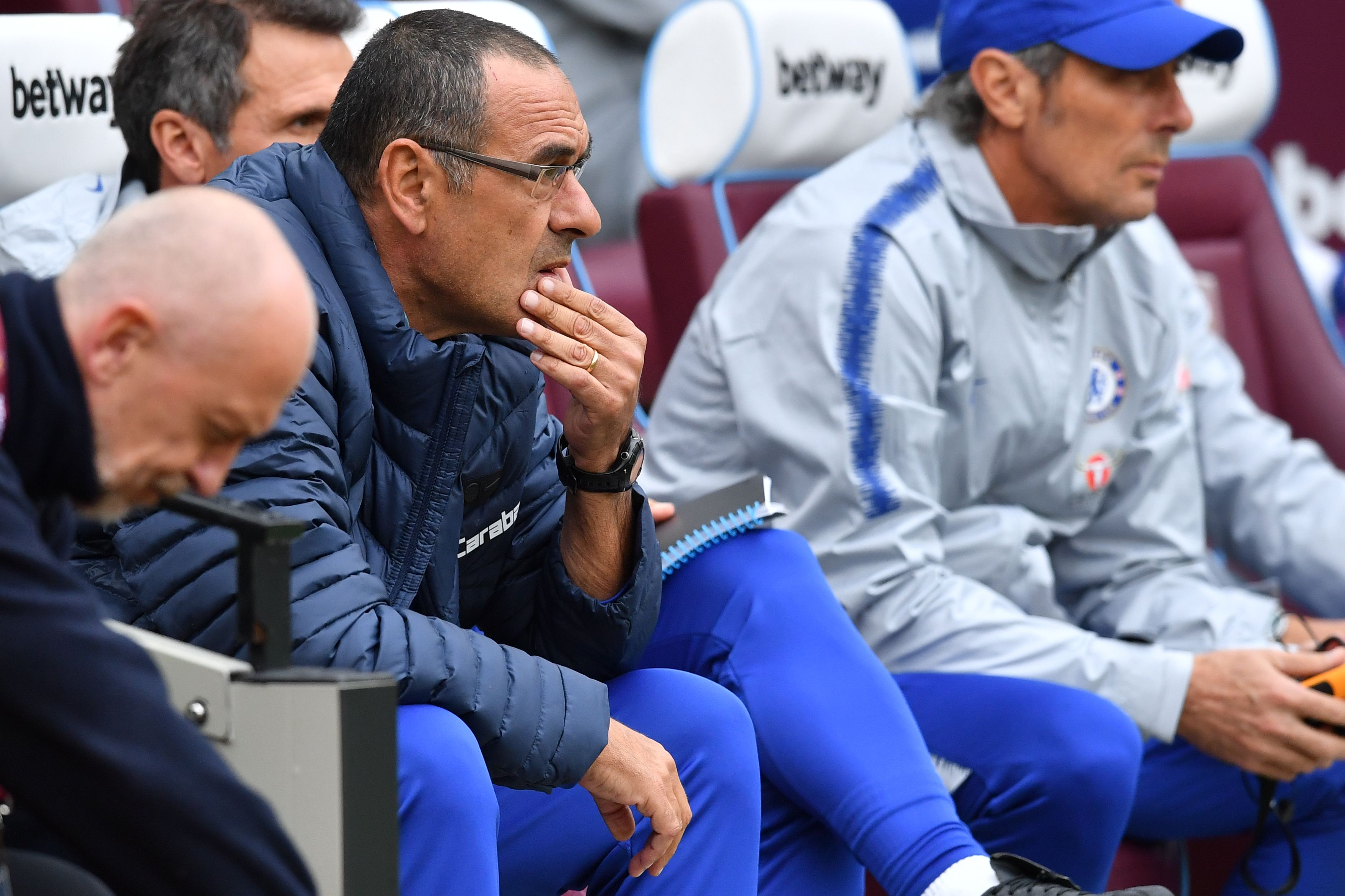 Chelsea's Italian head coach Maurizio Sarri awaits kick off in the English Premier League football match between West Ham United and Chelsea at The London Stadium, in east London on September 23, 2018. (Photo by Ben STANSALL / AFP) / RESTRICTED TO EDITORIAL USE. No use with unauthorized audio, video, data, fixture lists, club/league logos or 'live' services. Online in-match use limited to 120 images. An additional 40 images may be used in extra time. No video emulation. Social media in-match use limited to 120 images. An additional 40 images may be used in extra time. No use in betting publications, games or single club/league/player publications. / (Photo credit should read BEN STANSALL/AFP/Getty Images)