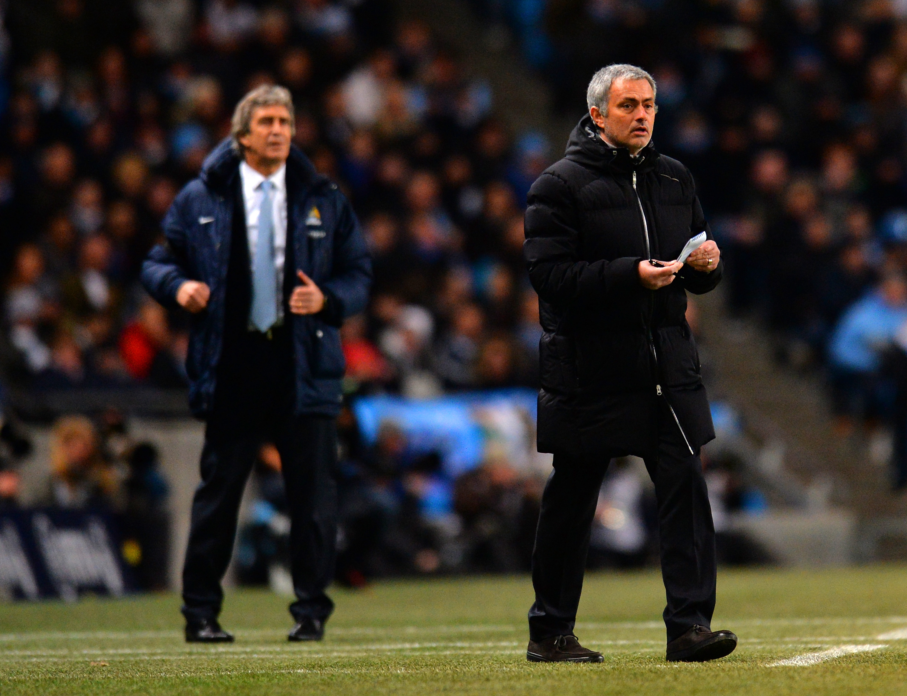 MANCHESTER, ENGLAND - FEBRUARY 03: Manuel Pellegrini manager of Manchester City and Jose Mourinho manager of Chelsea give instructions during the Barclays Premier League match between Manchester City and Chelsea at Etihad Stadium on February 3, 2014 in Manchester, England.  (Photo by Shaun Botterill/Getty Images)