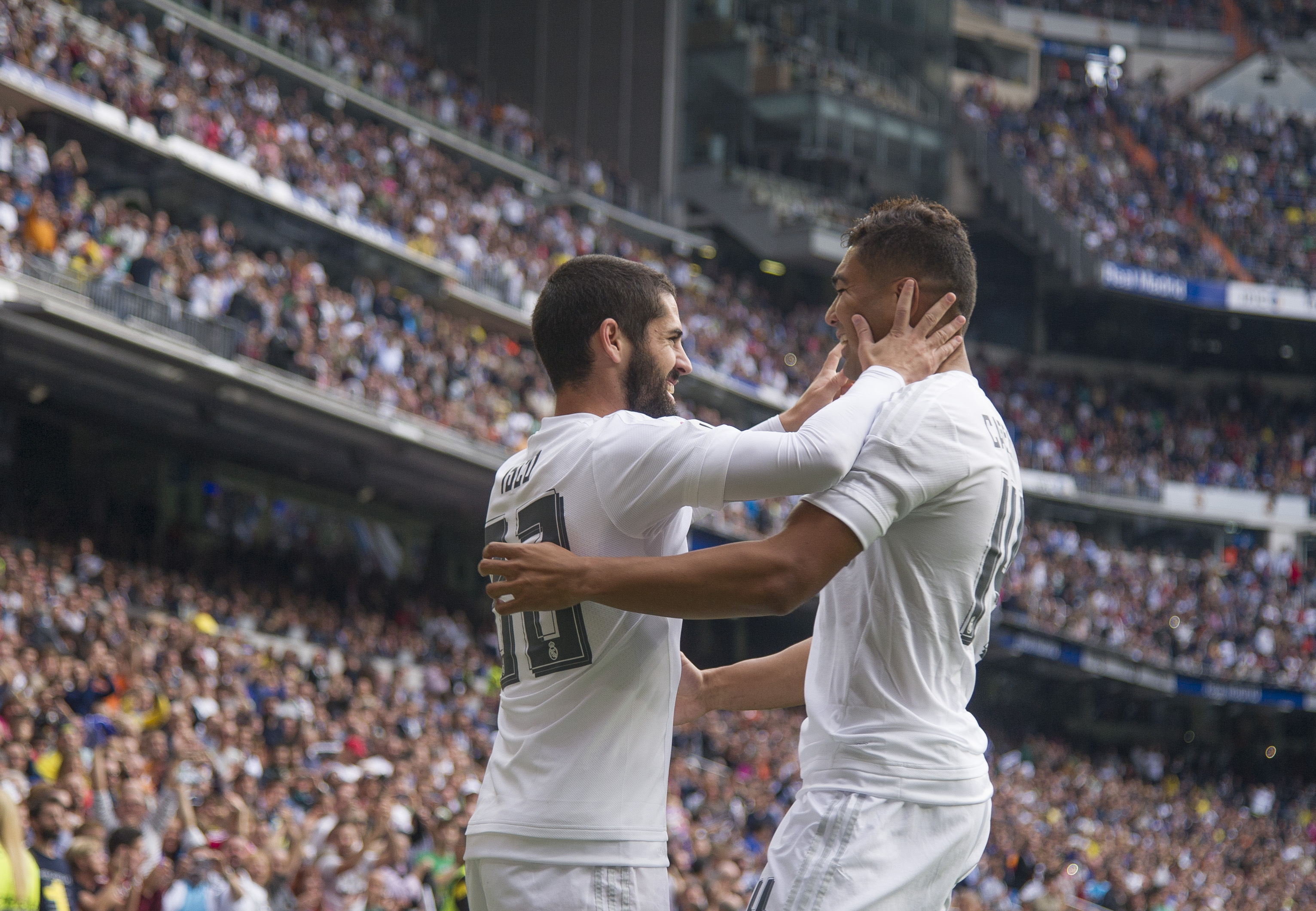 Real Madrid's midfielder Isco (L) celebrates a goal with Real Madrid's Brazilian midfielder Casimiro during the Spanish league football match Real Madrid CF vs UD Las Palmas at the Santiago Bernabeu stadium in Madrid on October 31, 2015. AFP PHOTO / CURTO DE LA TORRE (Photo by CURTO DE LA TORRE / AFP) (Photo credit should read CURTO DE LA TORRE/AFP/Getty Images)