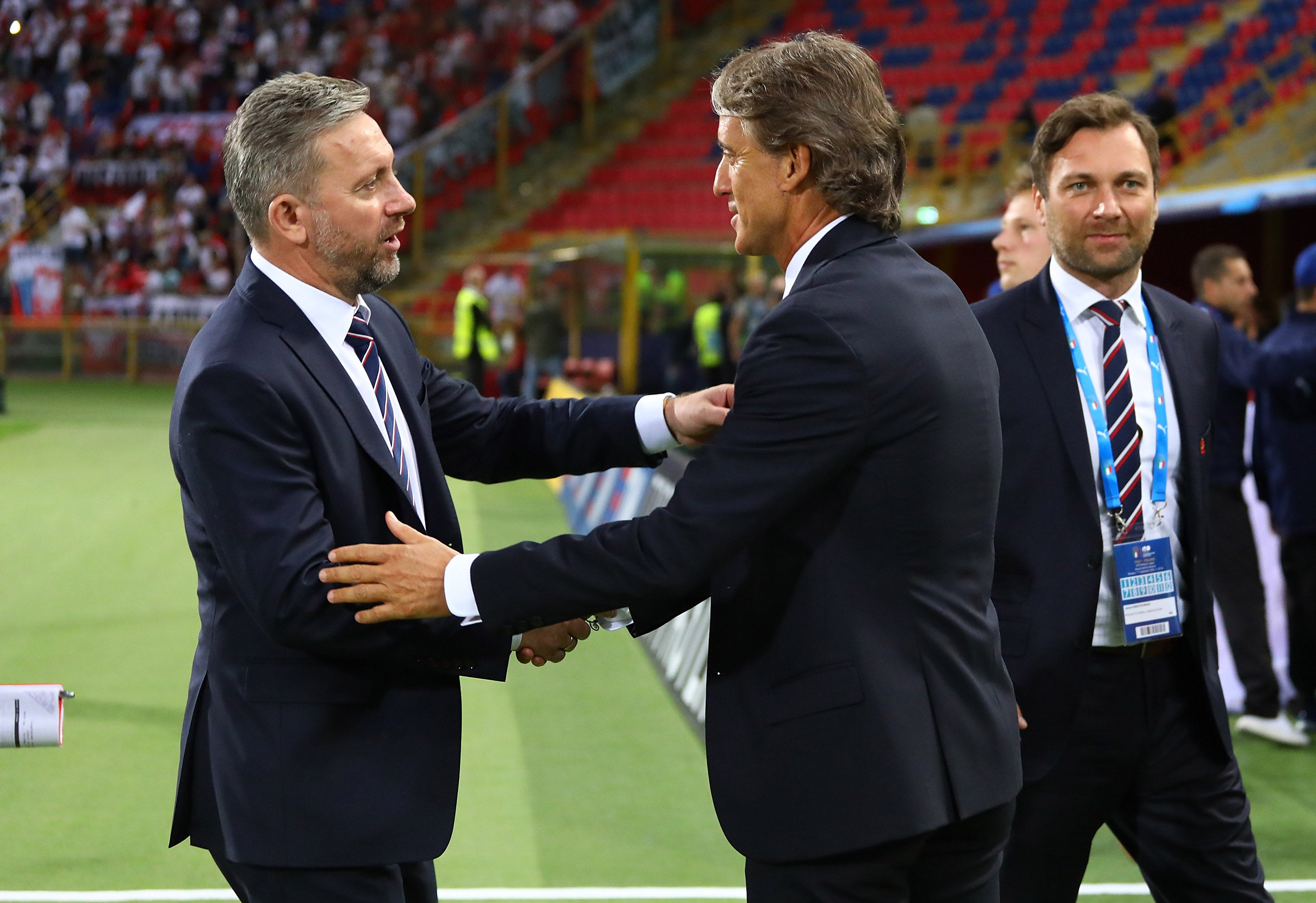 BOLOGNA, ITALY - SEPTEMBER 07: Head coach of Italy Roberto Mancini and head coach of Poland Jerzy Brzeczek greet before the national anthem before the UEFA Nations League A group three match between Italy and Poland at Stadio Renato Dall'Ara on September 7, 2018 in Bologna, Italy. (Photo by Marco Luzzani/Getty Images)