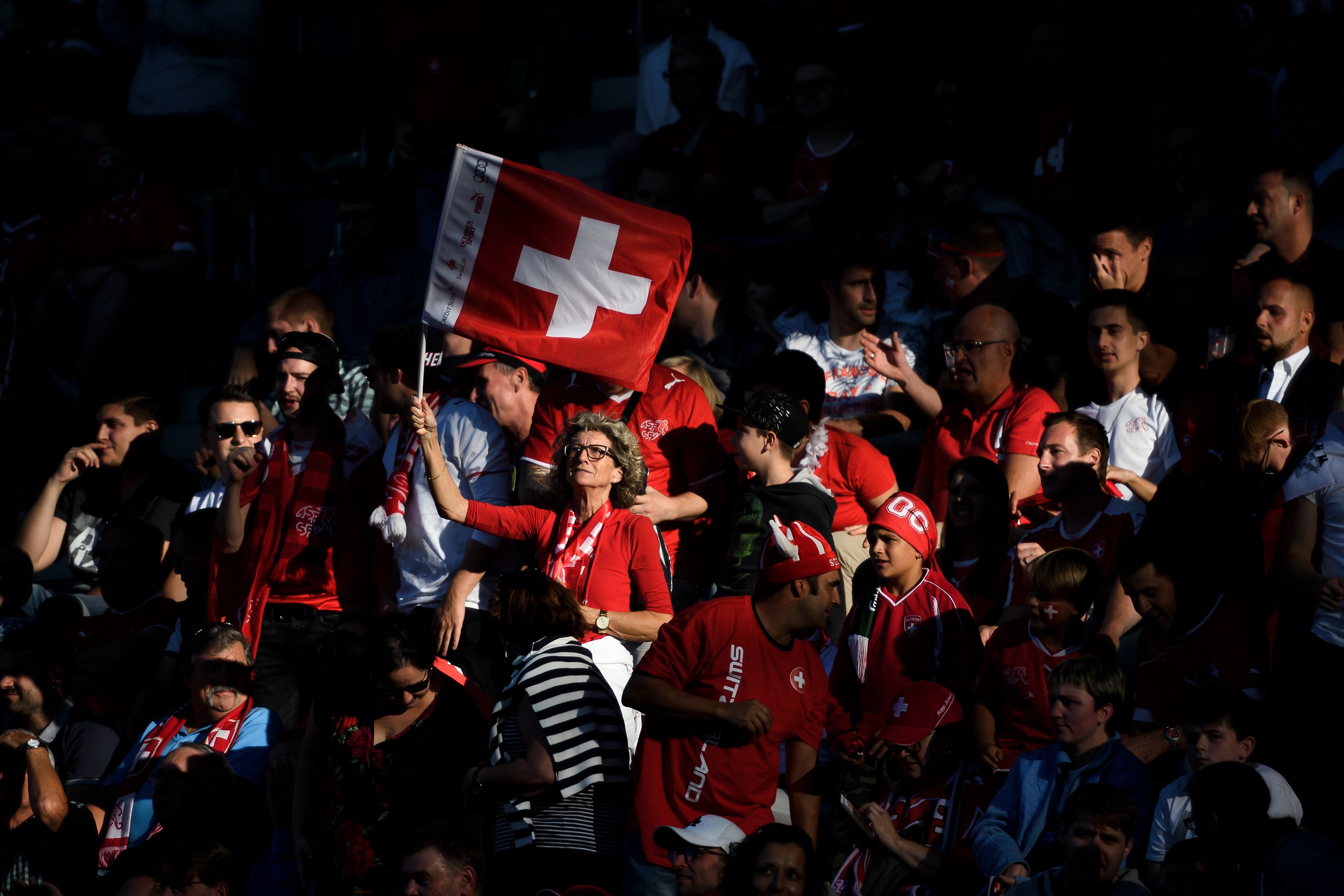 A supporter waves a Swiss flag during the UEFA Nations League football match between Switzerland and Iceland at the Kybunpark stadium in St Gallen on September 8, 2018. (Photo by Fabrice COFFRINI / AFP) (Photo credit should read FABRICE COFFRINI/AFP/Getty Images)