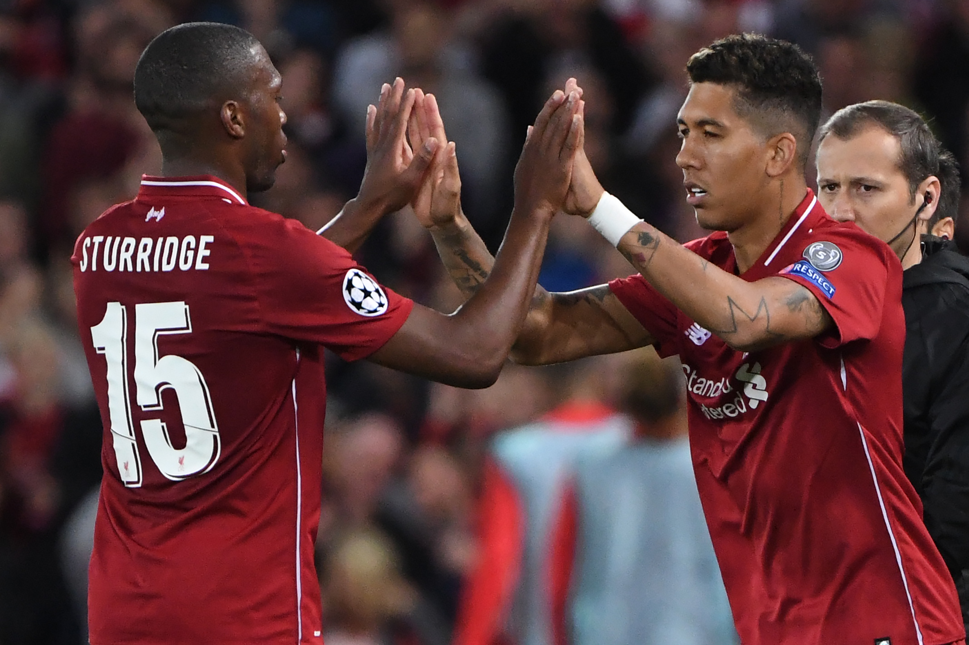 TOPSHOT - Liverpool's Brazilian midfielder Roberto Firmino (R) replaces Liverpool's English striker Daniel Sturridge during the UEFA Champions League group C football match between Liverpool and Paris Saint-Germain at Anfield in Liverpool, north west England on September 18, 2018. (Photo by Paul ELLIS / AFP) (Photo credit should read PAUL ELLIS/AFP/Getty Images)