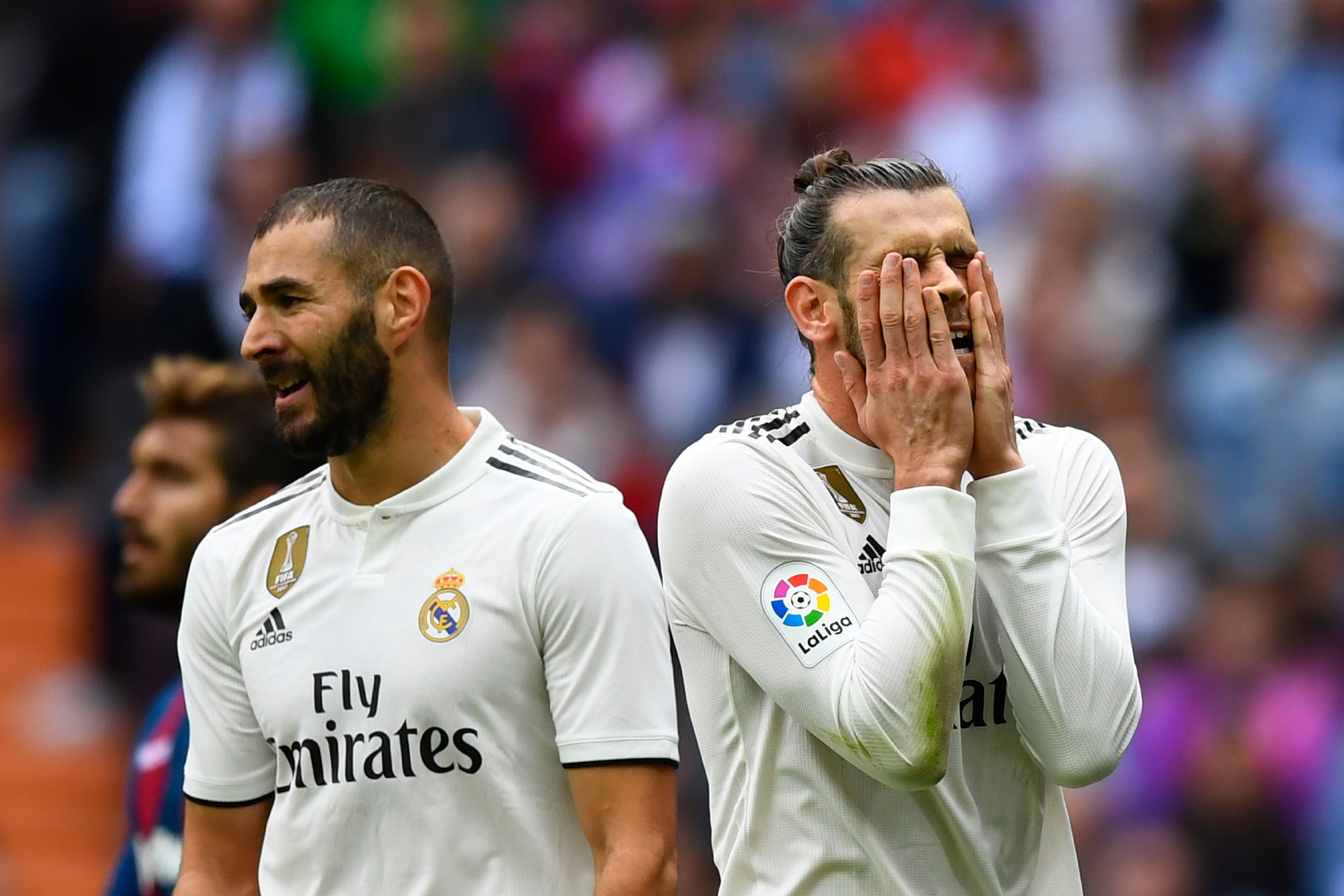 Real Madrid's Welsh forward Gareth Bale (R) reacts next to Real Madrid's French forward Karim Benzema during the Spanish league football match Real Madrid CF against Levante UD at the Santiago Bernabeu stadium in Madrid on October 20, 2018. (Photo by GABRIEL BOUYS / AFP) (Photo credit should read GABRIEL BOUYS/AFP/Getty Images)