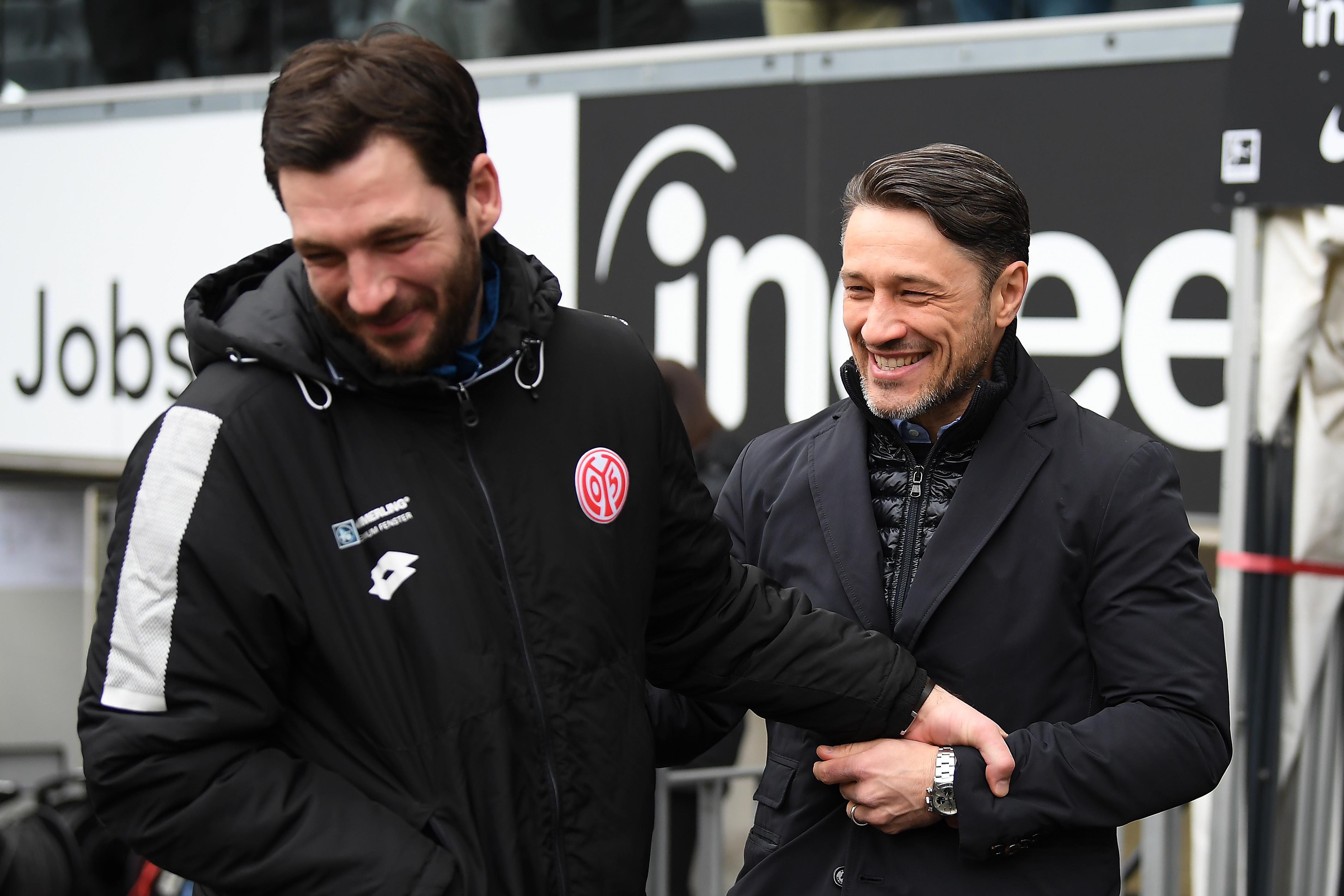 FRANKFURT AM MAIN, GERMANY - MARCH 17: Sandro Schwarz, coach of Mainz, (l) talks with Coach Niko Kovac of Frankfurt before the Bundesliga match between Eintracht Frankfurt and 1. FSV Mainz 05 at Commerzbank-Arena on March 17, 2018 in Frankfurt am Main, Germany. (Photo by Matthias Hangst/Bongarts/Getty Images)