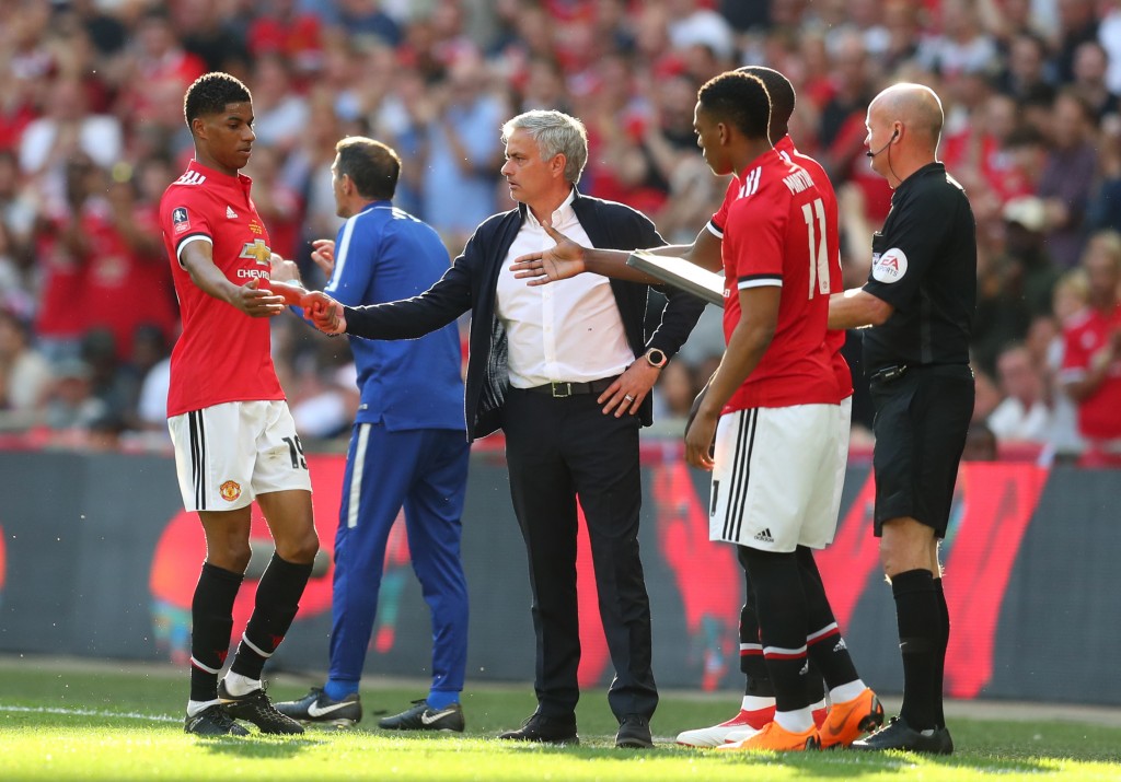 Trying to protect his player. (Picture Courtesy - AFP/Getty Images)