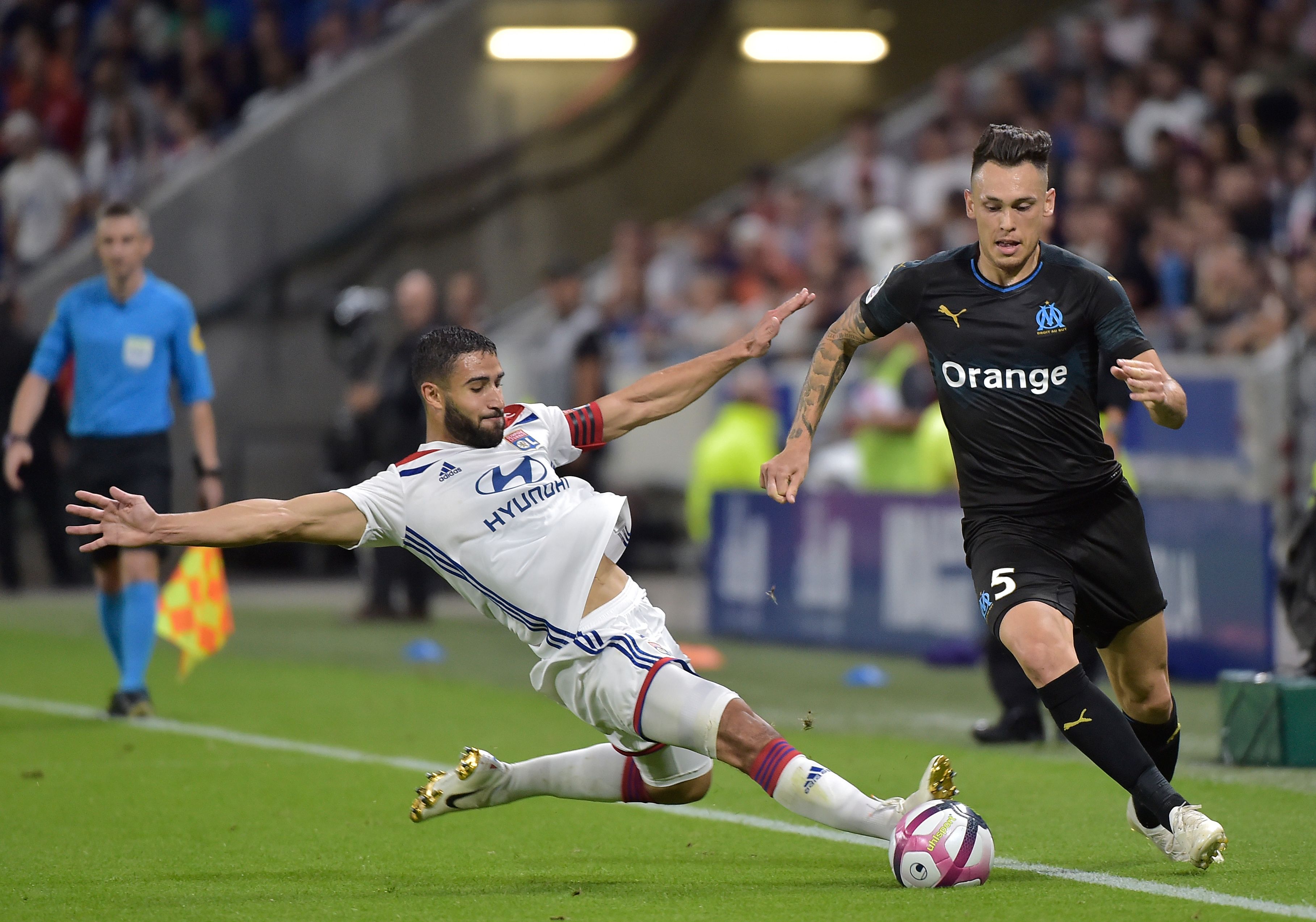 Marseille's Argentinian forward Lucas Ocampos (R) is tackled by Lyon's French forward Nabil Fekir (L) during the French L1 football match between Lyon (OL) and Marseille (OM) on September 23, 2018 at the Groupama stadium in Décines-Charpieu near Lyon. (Photo by ROMAIN LAFABREGUE / AFP) (Photo credit should read ROMAIN LAFABREGUE/AFP/Getty Images)
