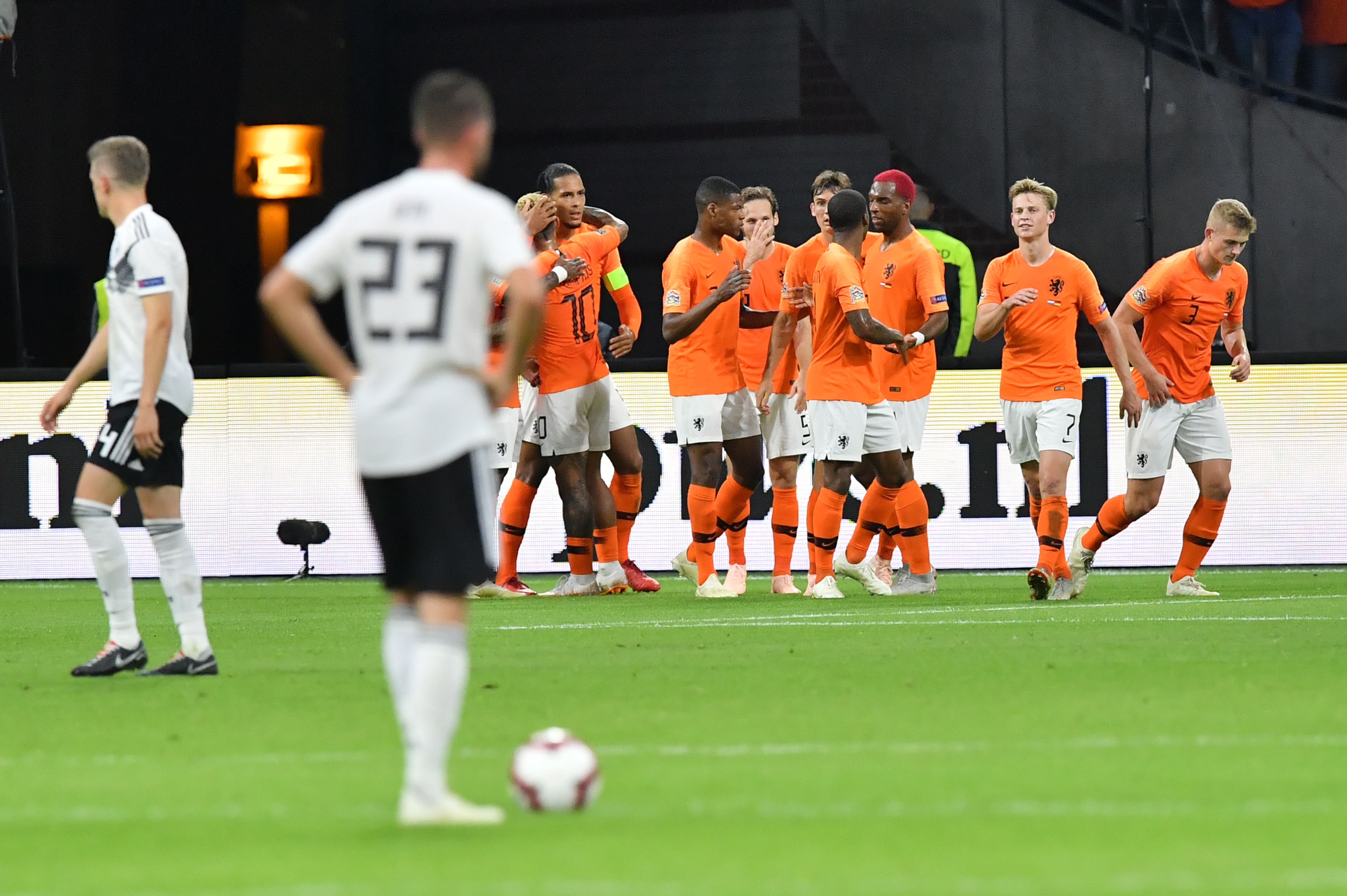 Netherlands' defender Virgil van Dijk (4thL) celebrates with teammates after scoring the opening goal during the UEFA Nations League football match between Netherlands and Germany, on October 13, 2018 at Johan Crujiff ArenA in Amsterdam. (Photo by EMMANUEL DUNAND / AFP) (Photo credit should read EMMANUEL DUNAND/AFP/Getty Images)