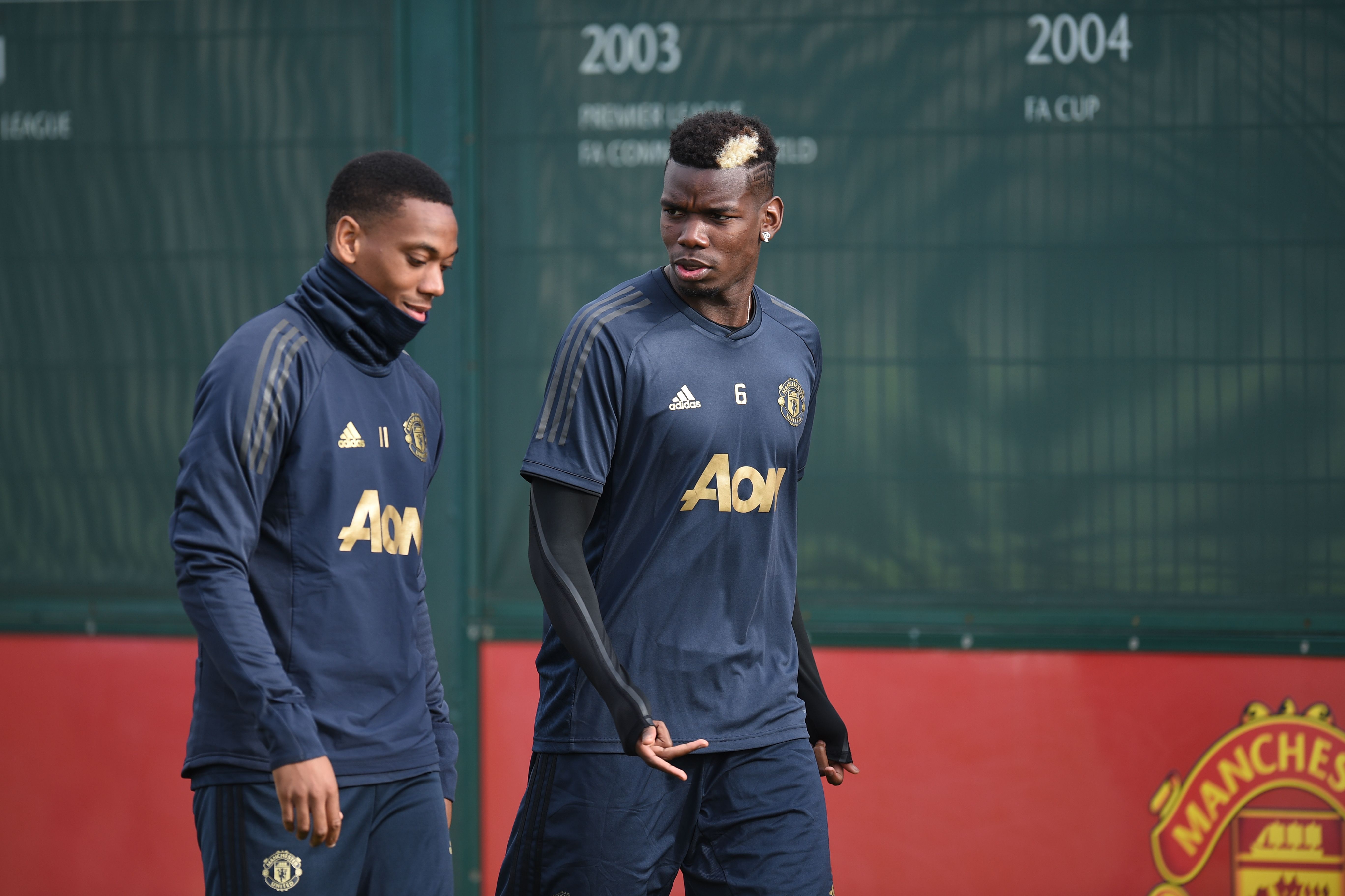 Manchester United's French striker Anthony Martial (L) and Manchester United's French midfielder Paul Pogba (R) arrive for a training session at the Carrington Training complex in Manchester, north west England on October 22, 2018, ahead of their UEFA Champions League group H football match against Juventus on October 23. (Photo by Oli SCARFF / AFP) (Photo credit should read OLI SCARFF/AFP/Getty Images)