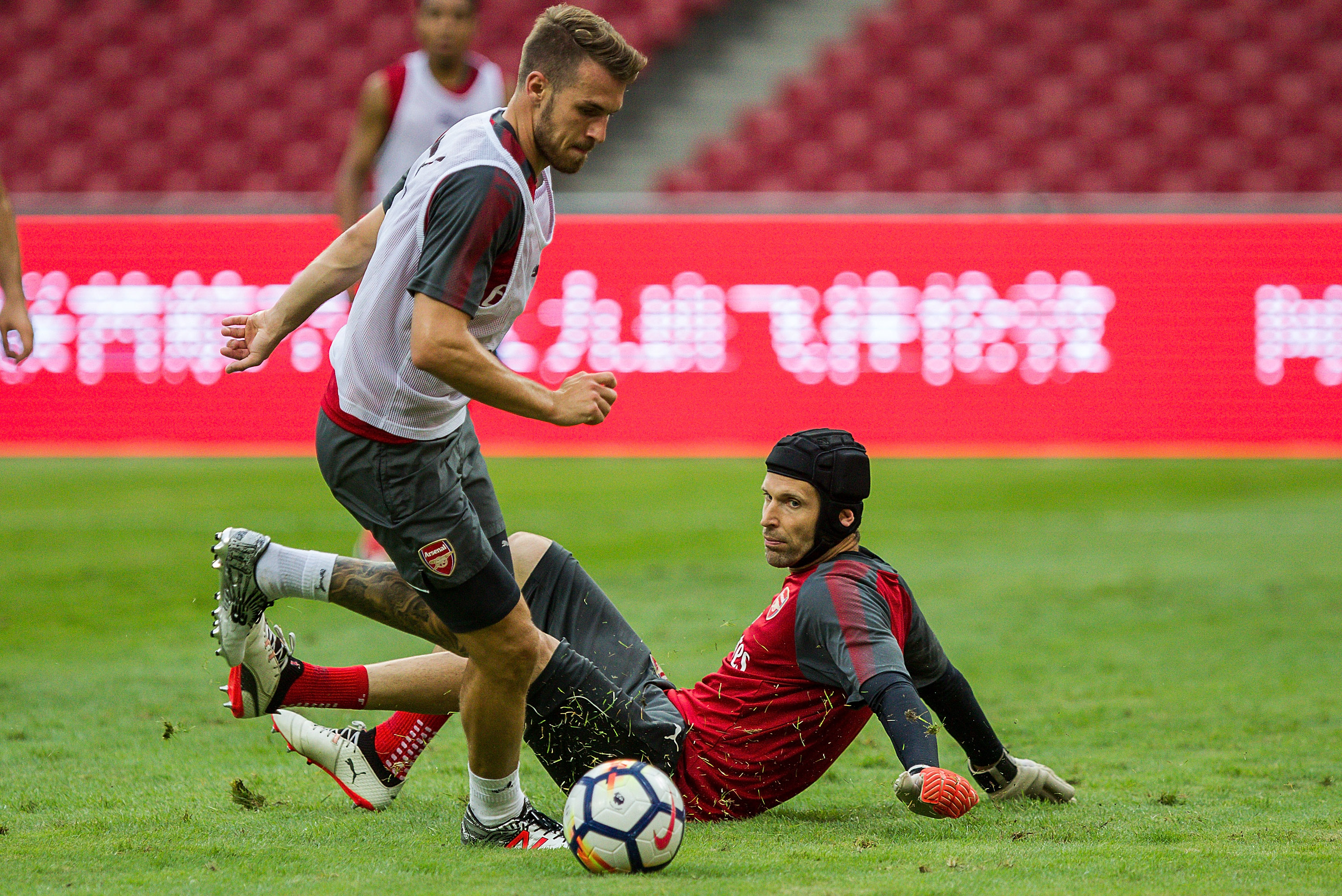 BEIJING, CHINA - JULY 21: Aaron Ramsey goes past Petr Cech of Arsenal during a training session at Birds Nest on July 21, 2017 in Beijing, China. (Photo by Yifan Ding/Getty Images)