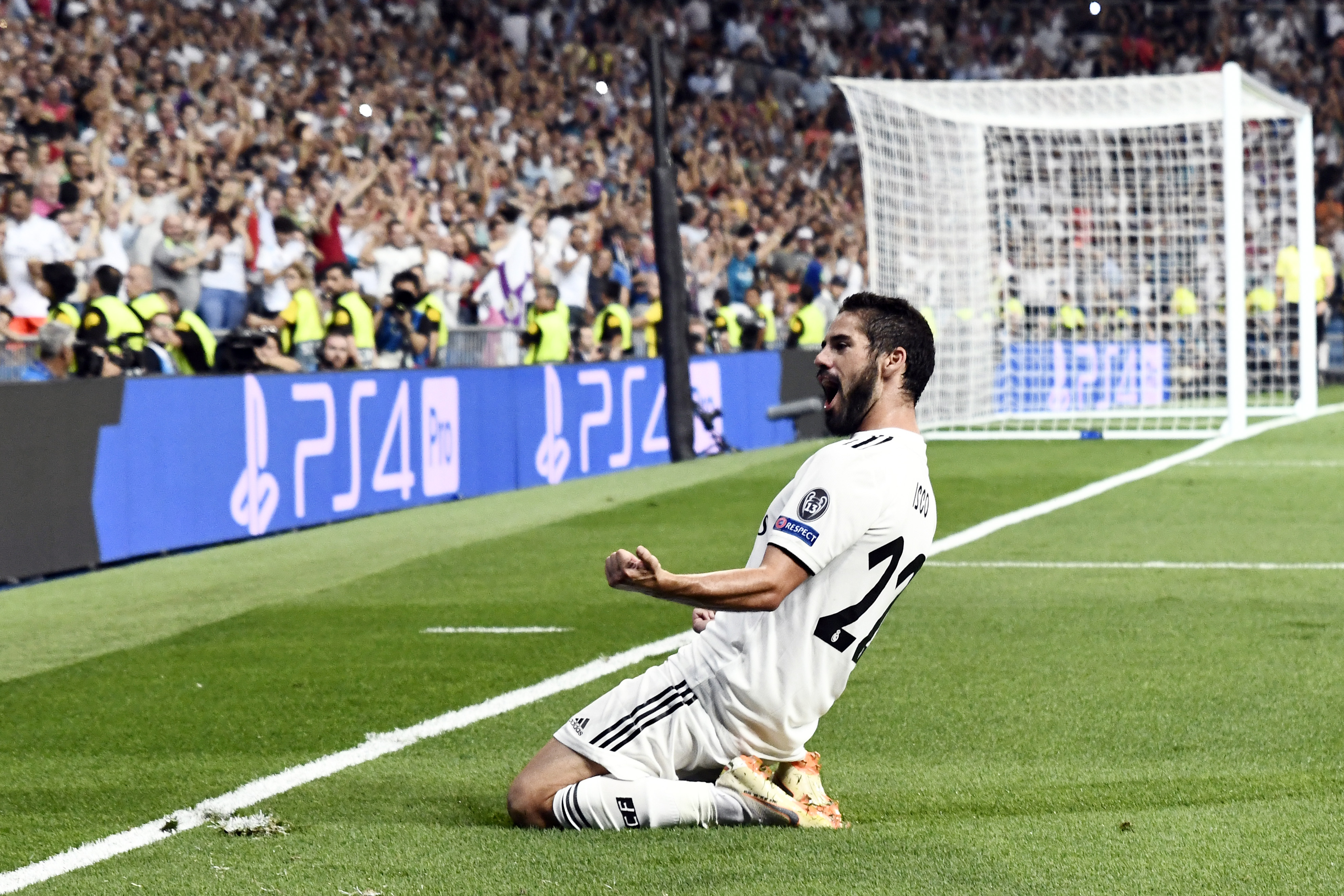 Real Madrid's Spanish midfielder Isco celebrates his team's opening goal during the UEFA Champions League group G football match between Real Madrid CF and AS Roma at the Santiago Bernabeu stadium in Madrid on September 19, 2018. (Photo by OSCAR DEL POZO / AFP)        (Photo credit should read OSCAR DEL POZO/AFP/Getty Images)
