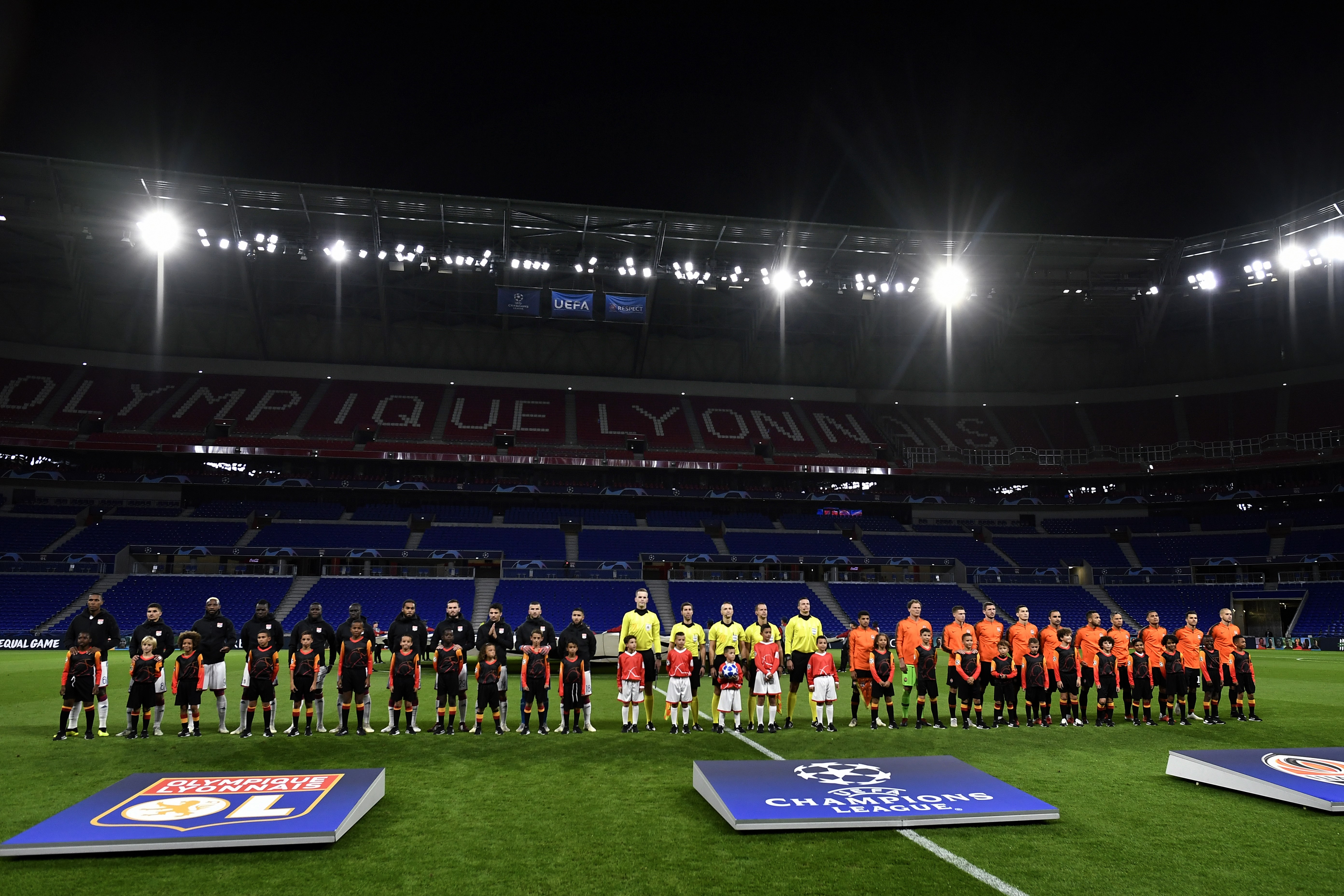 Lyon (L) and Shakthar Donetsk teams pose in an empty stadium before their UEFA Champions League Group F football match Olympique Lyonnais vs FC Shakhtar Donetsk at the OL stadium in Decines-Charpieu on October 2, 2018. - Lyon was ordered by UEFA to play its first Champions League group-stage home game without public as a punishment for racism and crowd disorder in last season's Europa League. (Photo by JEFF PACHOUD / AFP) (Photo credit should read JEFF PACHOUD/AFP/Getty Images)