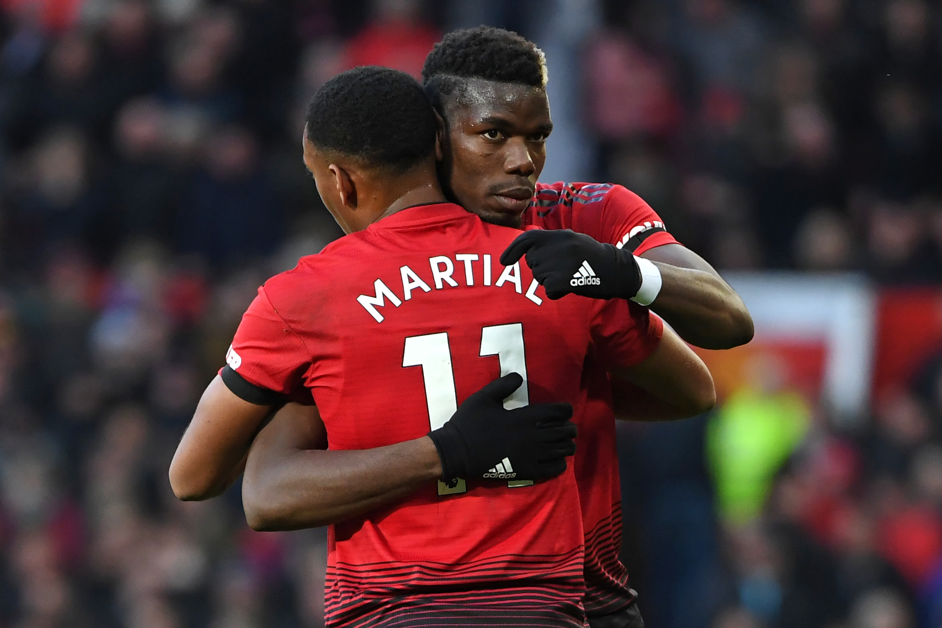 Manchester United's French midfielder Paul Pogba celebrates with Manchester United's French striker Anthony Martial (L) after scoring the opening goal of the English Premier League football match between Manchester United and Everton at Old Trafford in Manchester, north west England, on October 28, 2018. (Photo by Paul ELLIS / AFP) / RESTRICTED TO EDITORIAL USE. No use with unauthorized audio, video, data, fixture lists, club/league logos or 'live' services. Online in-match use limited to 120 images. An additional 40 images may be used in extra time. No video emulation. Social media in-match use limited to 120 images. An additional 40 images may be used in extra time. No use in betting publications, games or single club/league/player publications. / (Photo credit should read PAUL ELLIS/AFP/Getty Images)
