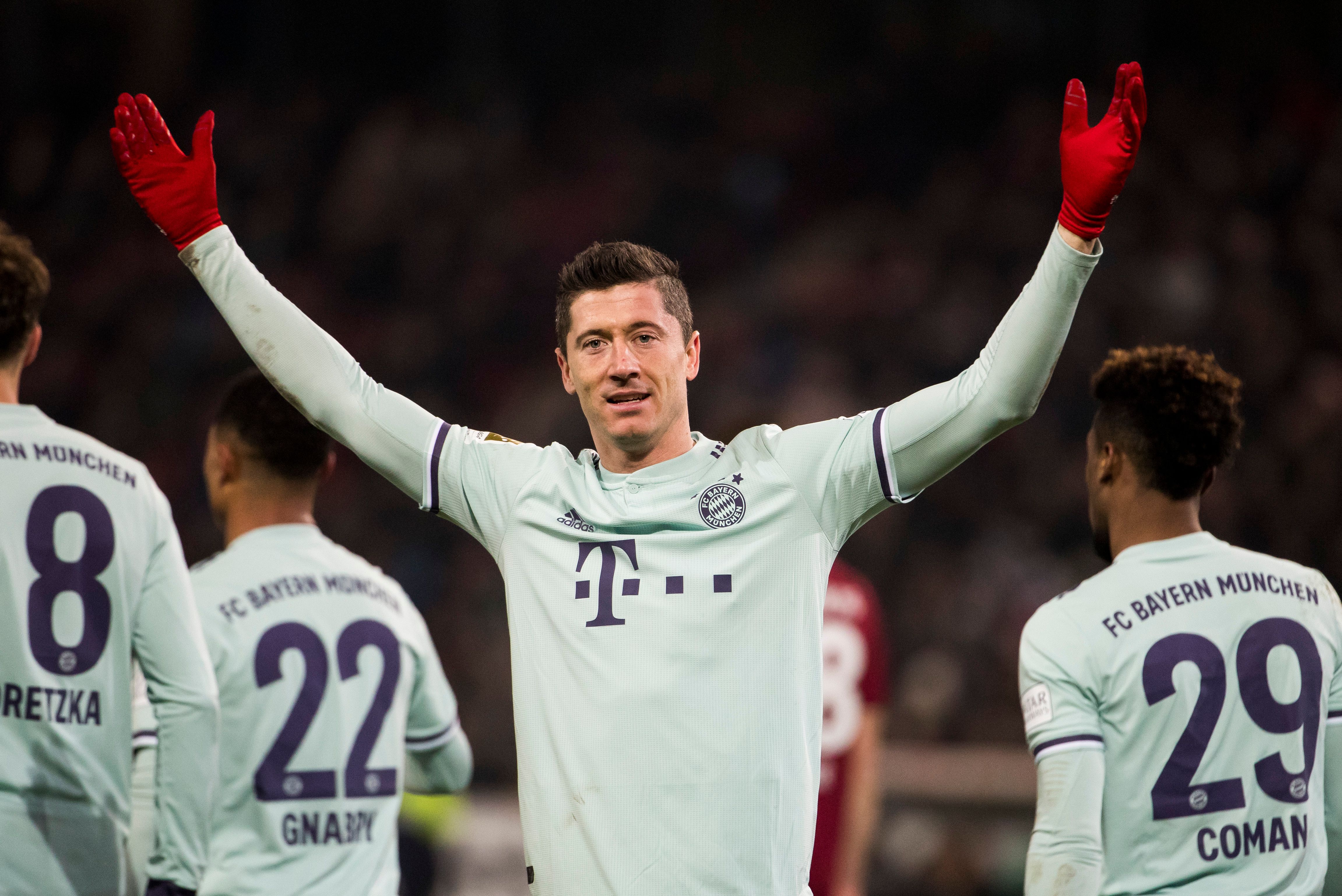 Bayern Munich's Polish forward Robert Lewandowski celebrates scoring his team's 4th goal during the German first division Bundesliga football match Hannover 96 v Bayern Munich at the HDI arena in Hanover, central Germany on December 15, 2018. (Photo by Odd ANDERSEN / AFP) / DFL REGULATIONS PROHIBIT ANY USE OF PHOTOGRAPHS AS IMAGE SEQUENCES AND/OR QUASI-VIDEO (Photo credit should read ODD ANDERSEN/AFP/Getty Images)