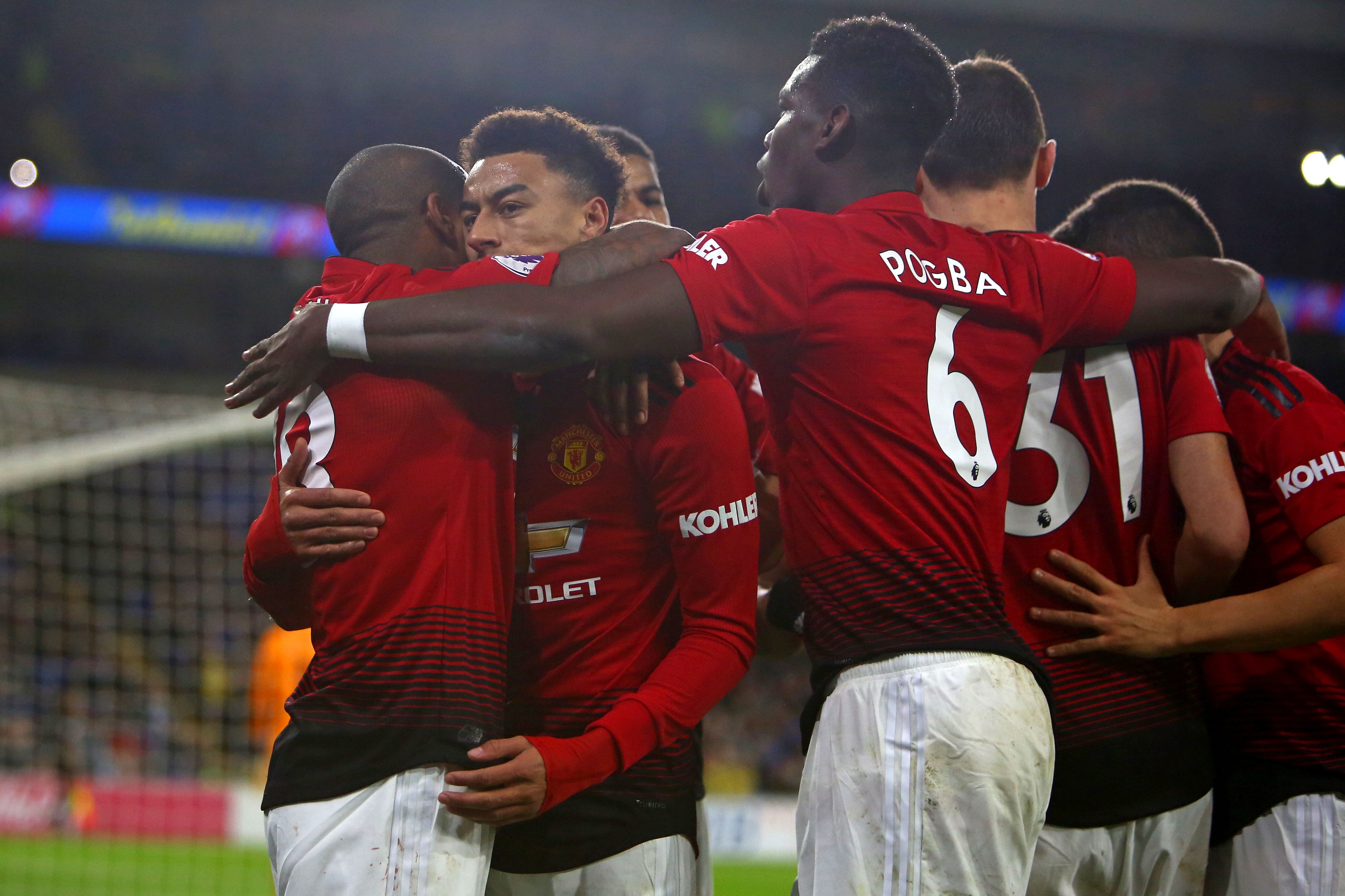 Manchester United's English midfielder Jesse Lingard (2nd L) celebrates with teammates after scoring their fourth goal from the penalty spot during the English Premier League football match between between Cardiff City and Manchester United at Cardiff City Stadium in Cardiff, south Wales on December 22, 2018. (Photo by Geoff CADDICK / AFP) / RESTRICTED TO EDITORIAL USE. No use with unauthorized audio, video, data, fixture lists, club/league logos or 'live' services. Online in-match use limited to 120 images. An additional 40 images may be used in extra time. No video emulation. Social media in-match use limited to 120 images. An additional 40 images may be used in extra time. No use in betting publications, games or single club/league/player publications. / (Photo credit should read GEOFF CADDICK/AFP/Getty Images)