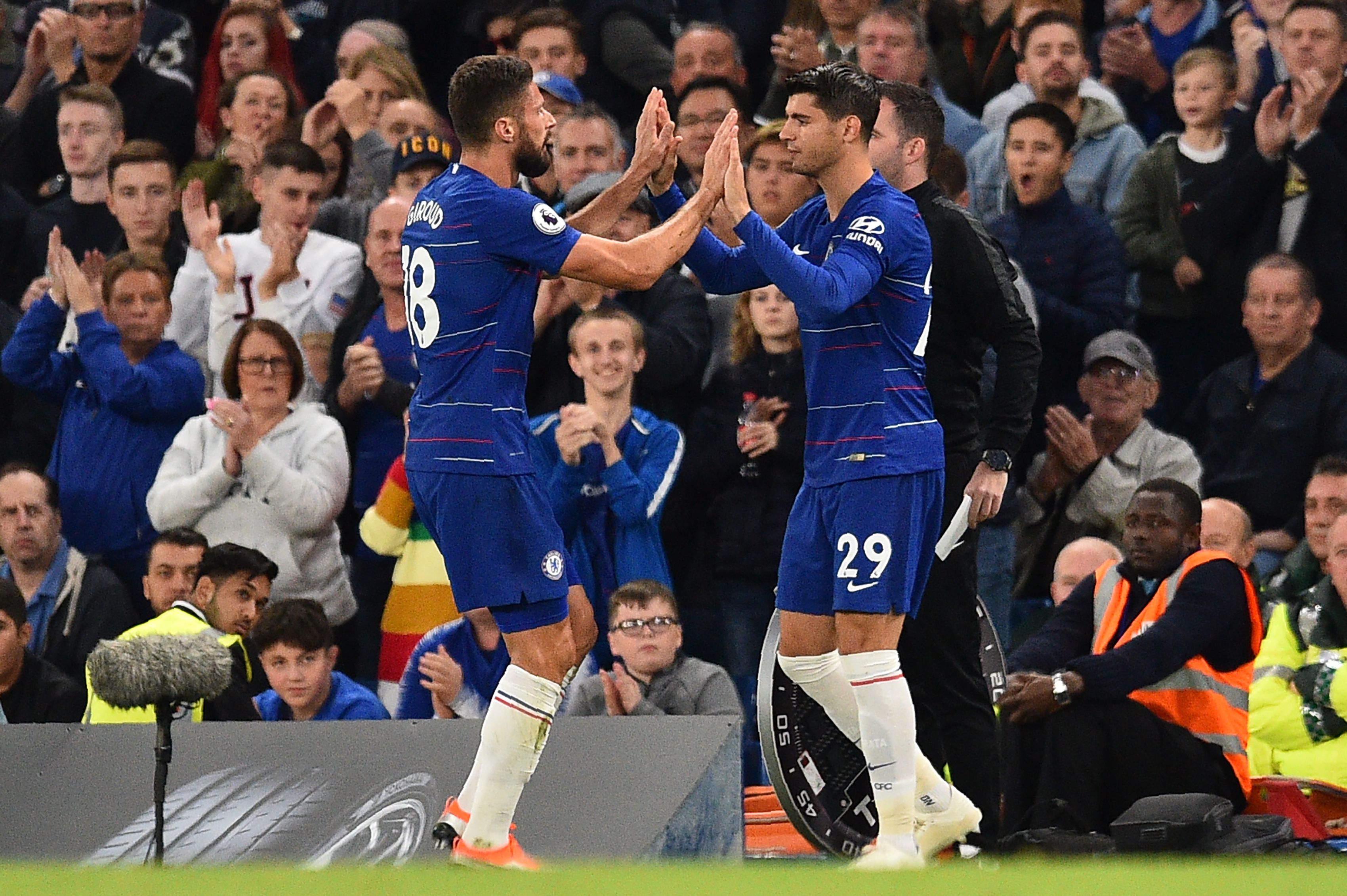 Chelsea's French striker Olivier Giroud (L) is substituted by Chelsea's Spanish striker Alvaro Morata during the English Premier League football match between Chelsea and Liverpool at Stamford Bridge in London on September 29, 2018. (Photo by Glyn KIRK / AFP) / RESTRICTED TO EDITORIAL USE. No use with unauthorized audio, video, data, fixture lists, club/league logos or 'live' services. Online in-match use limited to 120 images. An additional 40 images may be used in extra time. No video emulation. Social media in-match use limited to 120 images. An additional 40 images may be used in extra time. No use in betting publications, games or single club/league/player publications. / (Photo credit should read GLYN KIRK/AFP/Getty Images)