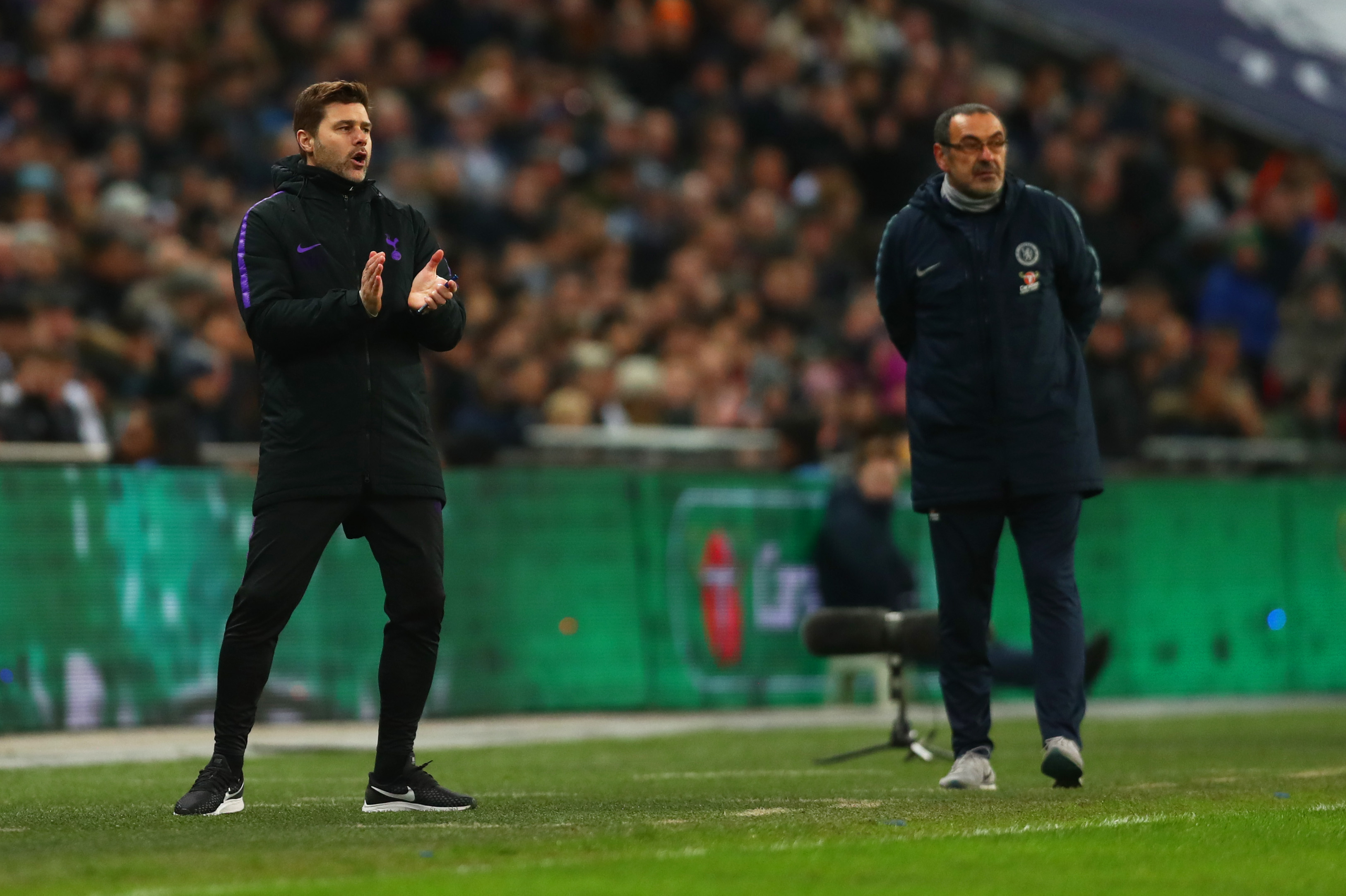 LONDON, ENGLAND - JANUARY 08: Mauricio Pochettino, Manager of Tottenham Hotspur gives his team instructions as Maurizio Sarri, Manager of Chelsea looks on during the Carabao Cup Semi-Final First Leg match between Tottenham Hotspur and Chelsea at Wembley Stadium on January 8, 2019 in London, England. (Photo by Clive Rose/Getty Images)