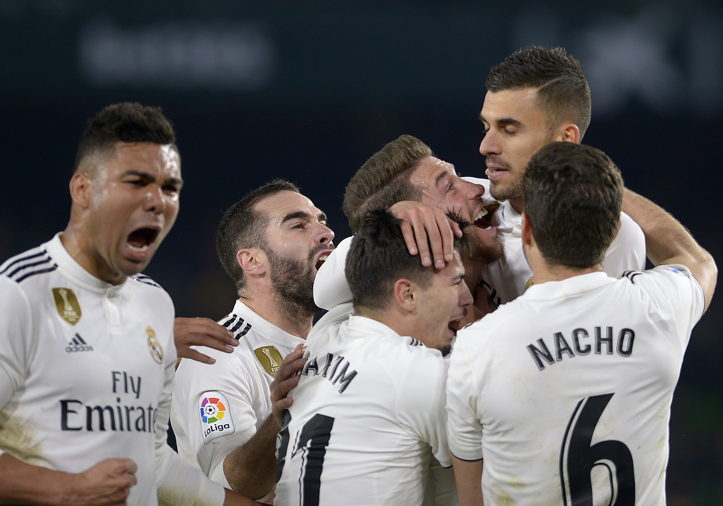 Real Madrid's Spanish midfielder Daniel Ceballos (2R) celebrates with teammates after scoring a goal during the Spanish League football match between Real Betis and Real Madrid CF at the Benito Villamarin stadium in Seville on January 13, 2019. (Photo by CRISTINA QUICLER / AFP) (Photo credit should read CRISTINA QUICLER/AFP/Getty Images)