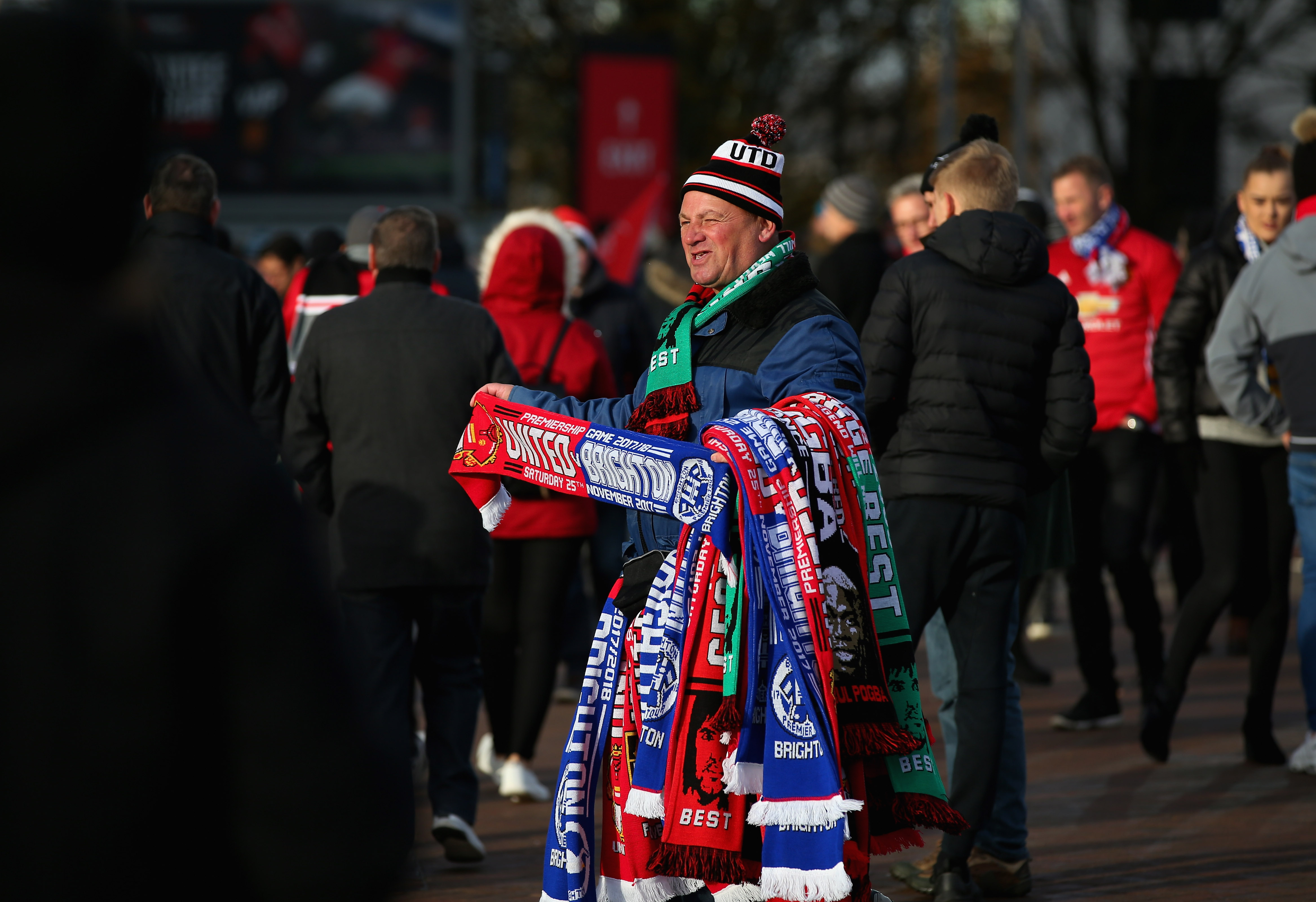 MANCHESTER, ENGLAND - NOVEMBER 25: A scarf seller is seen outside Old Trafford prior to the Premier League match between Manchester United and Brighton and Hove Albion at Old Trafford on November 25, 2017 in Manchester, England. (Photo by Alex Livesey/Getty Images)
