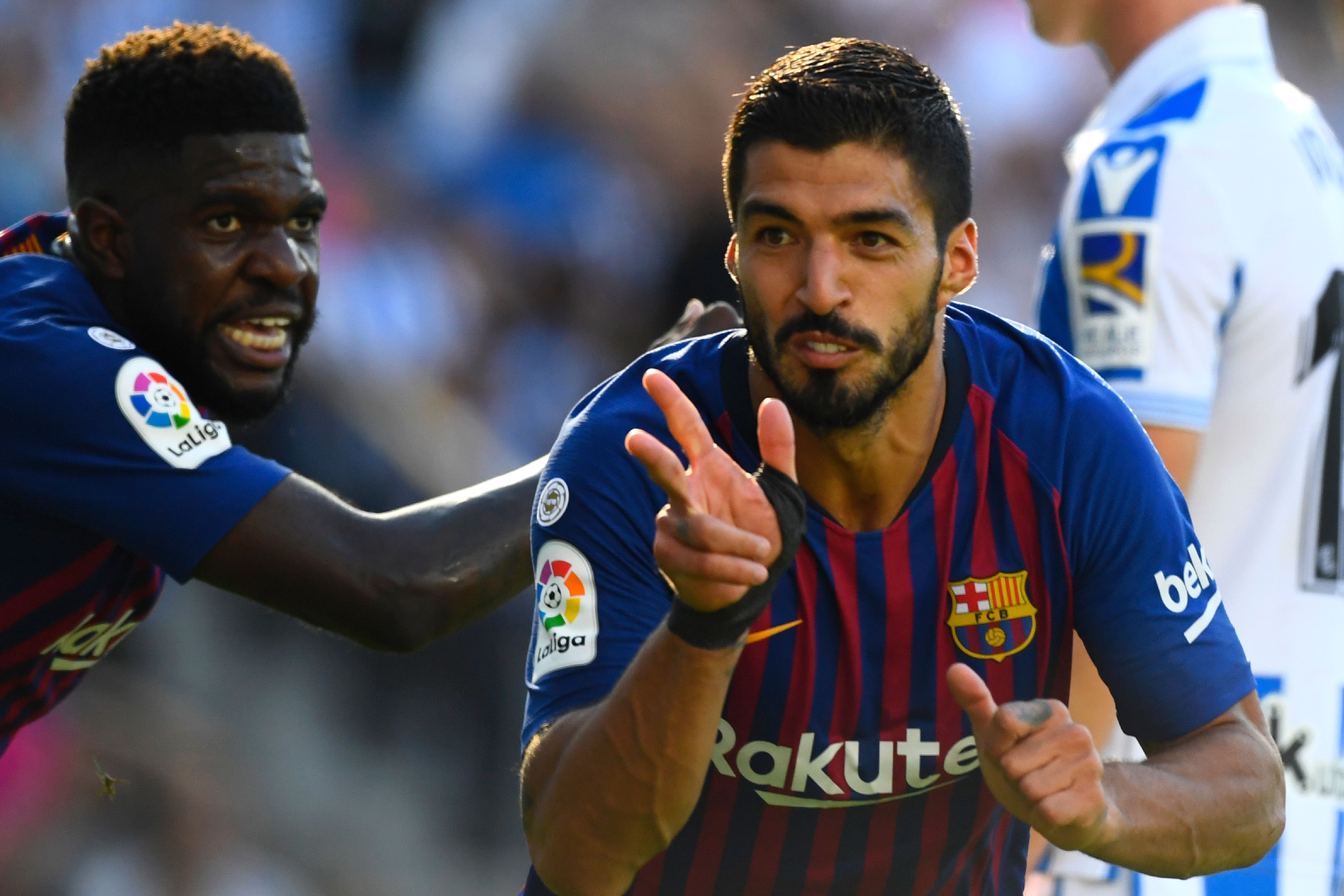 Barcelona's Uruguayan forward Luis Suarez (R) celebrates with Barcelona's French defender Samuel Umtiti after scoring a goal during the Spanish league football match between Real Sociedad and FC Barcelona at the Anoeta stadium in San Sebastian on September 15, 2018. (Photo by GABRIEL BOUYS / AFP) (Photo credit should read GABRIEL BOUYS/AFP/Getty Images)