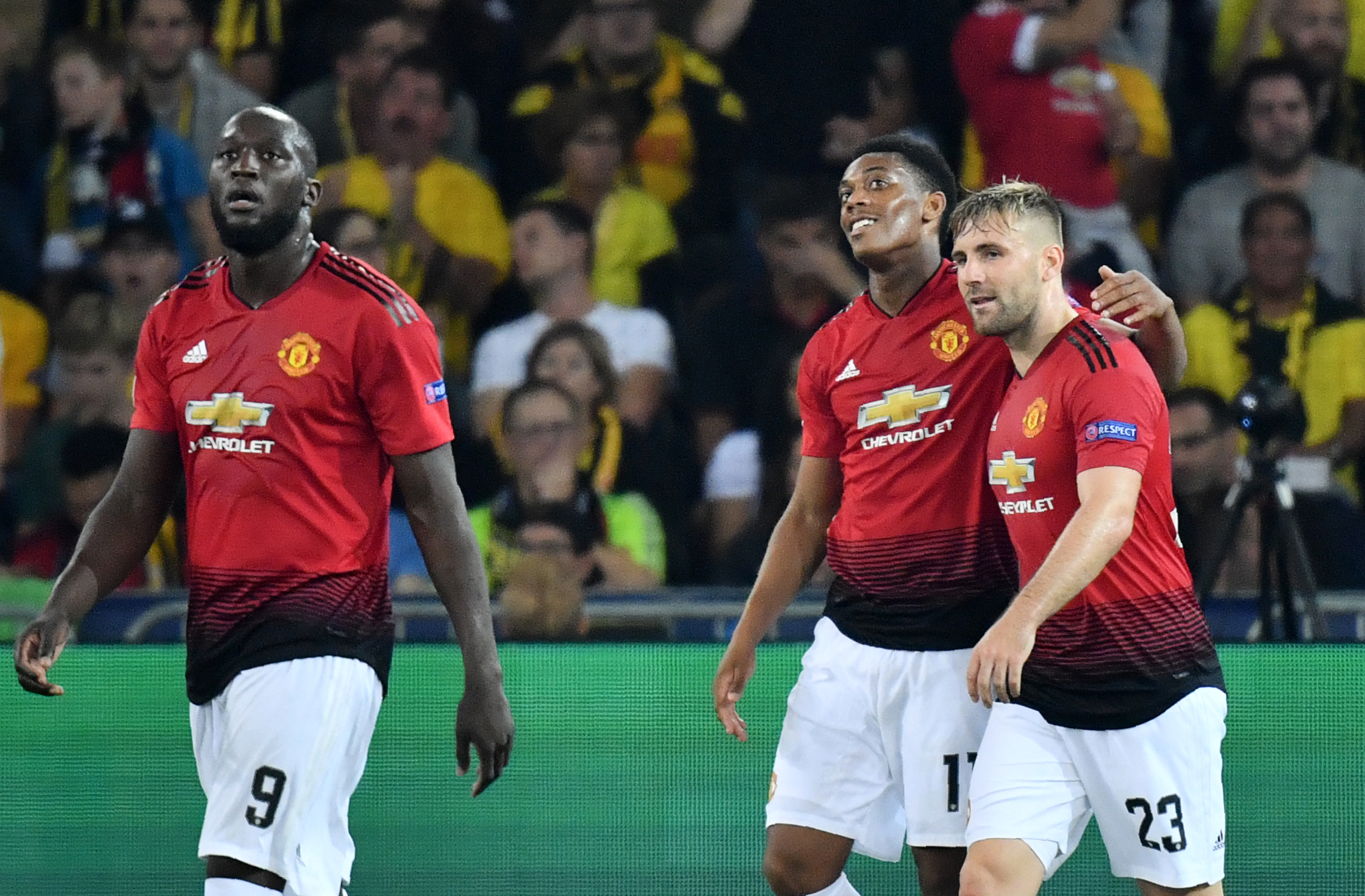 Manchester United's French striker Anthony Martial (C) celebrates after scoring with teammates Romelu Lukaku (L) and Luke Shaw (R) during the UEFA Champions League group H football match between Young Boys and Manchester United at The Stade de Suisse in Bern on September 19, 2018. (Photo by Alain GROSCLAUDE / AFP) (Photo credit should read ALAIN GROSCLAUDE/AFP/Getty Images)