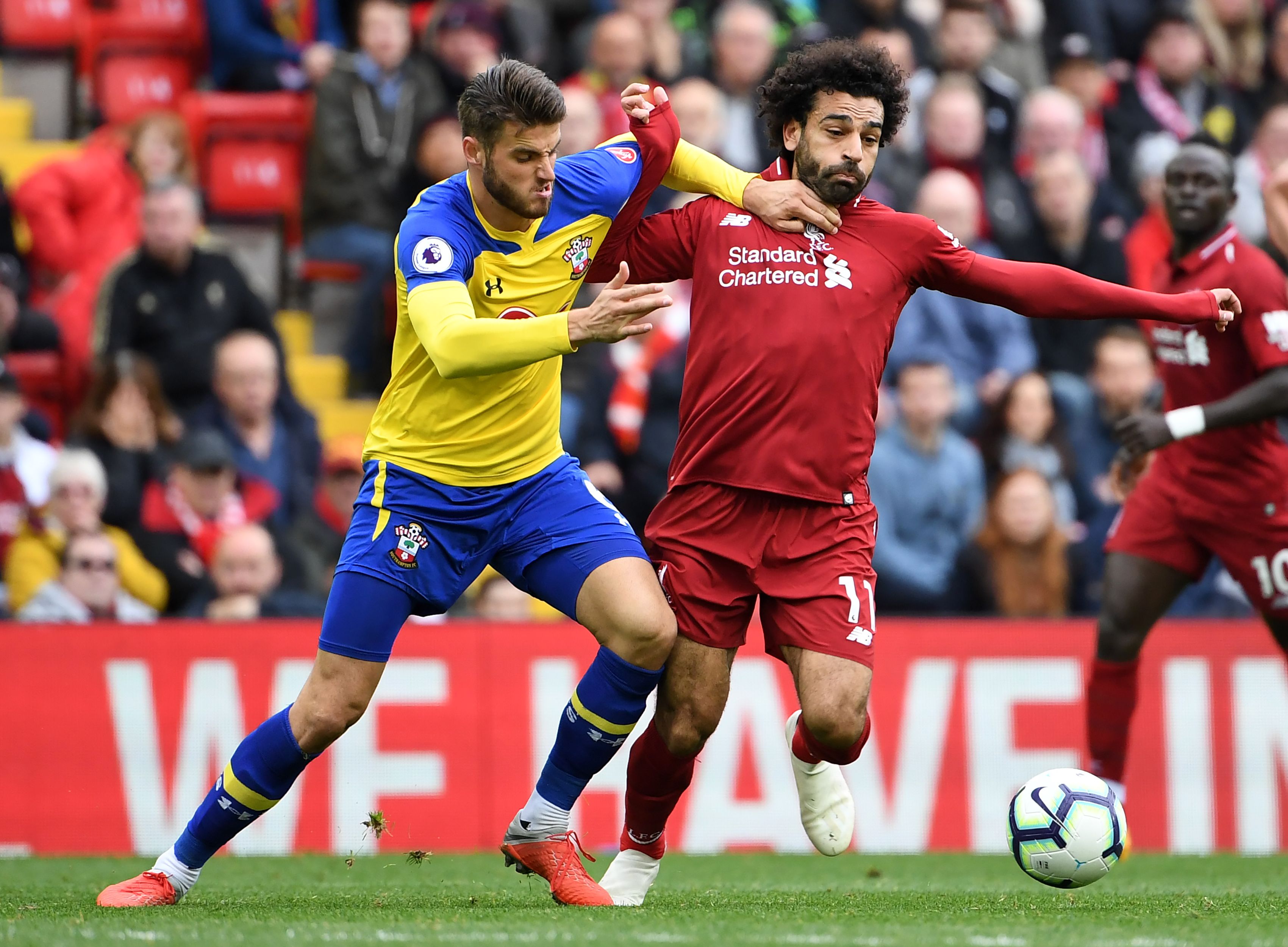 Southampton's English striker Danny Ings (L) vies with Liverpool's Egyptian midfielder Mohamed Salah during the English Premier League football match between Liverpool and Southampton at Anfield in Liverpool, north west England on September 22, 2018. (Photo by Paul ELLIS / AFP) / RESTRICTED TO EDITORIAL USE. No use with unauthorized audio, video, data, fixture lists, club/league logos or 'live' services. Online in-match use limited to 120 images. An additional 40 images may be used in extra time. No video emulation. Social media in-match use limited to 120 images. An additional 40 images may be used in extra time. No use in betting publications, games or single club/league/player publications. / (Photo credit should read PAUL ELLIS/AFP/Getty Images)